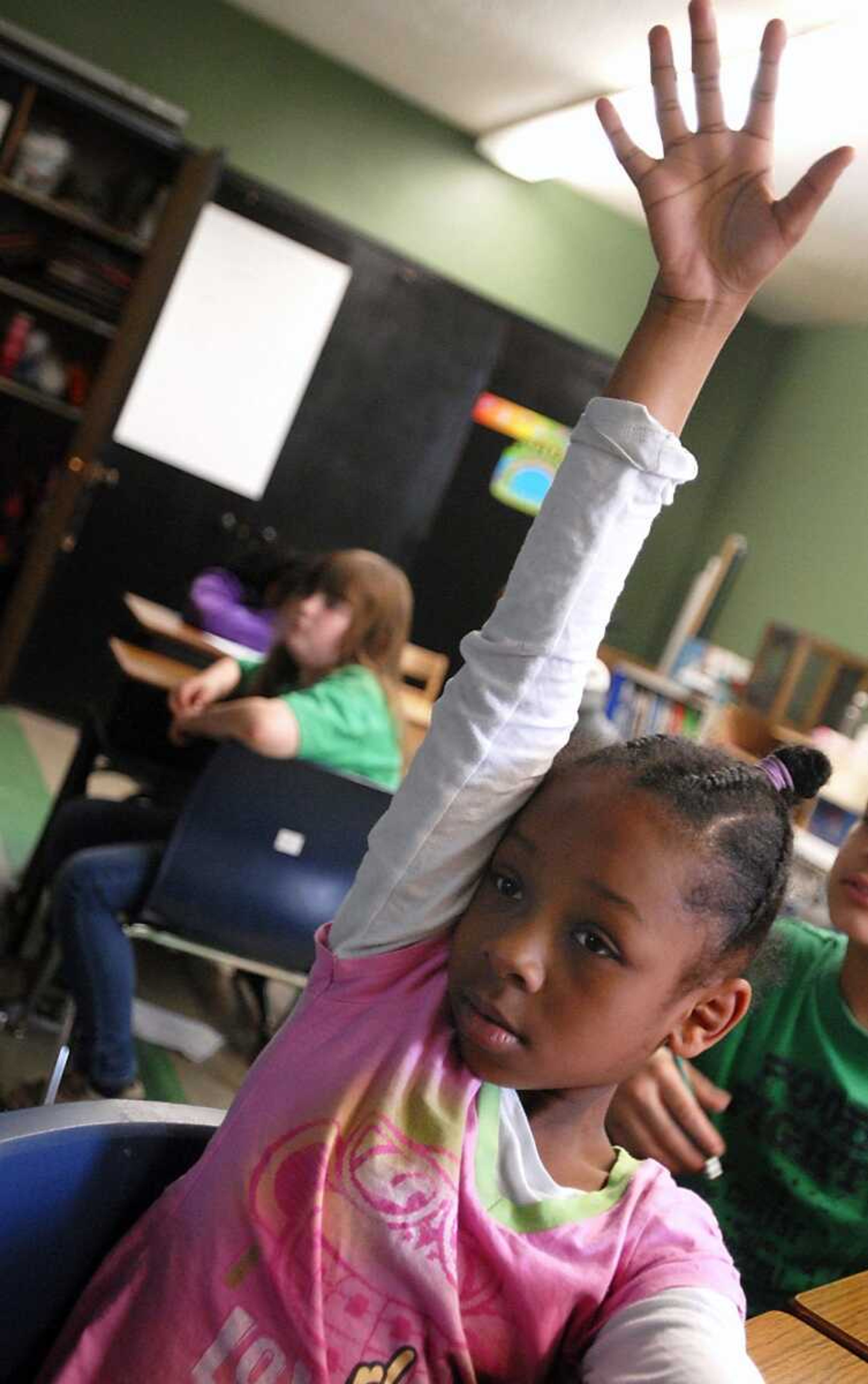 Fourth-grade students Camari Jones, foreground, and Lauren Hoxworth, background left, participate in a math lesson about fractions during class Thursday at Jefferson Elementary School in Cape Girardeau. Southeast Missouri State University has begun a campaign aimed at anticipating and preparing for the technological needs of the next decade of students. (Kristin Eberts)