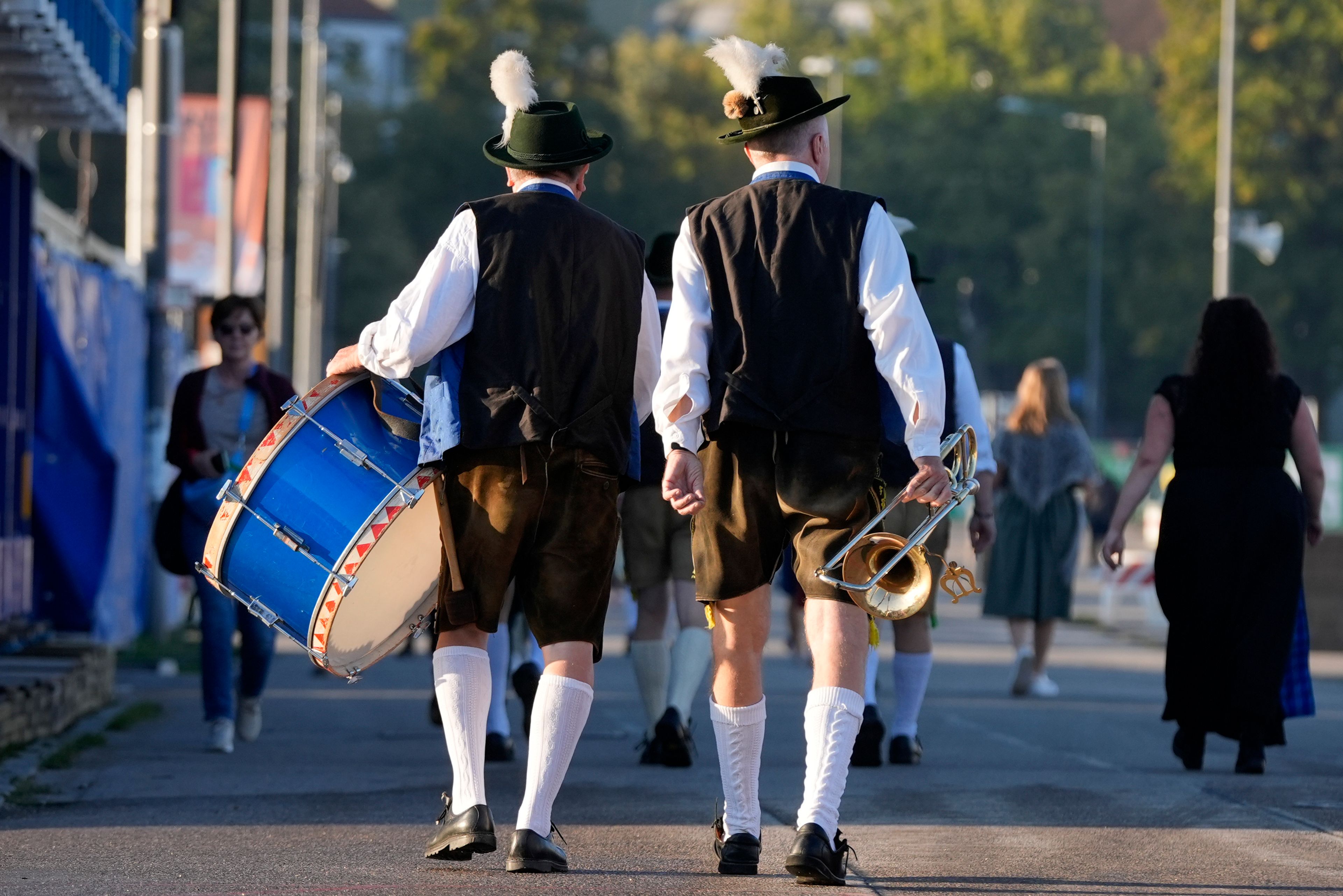 Bavarian musicians walk, at the start of the 189th 'Oktoberfest' beer festival in Munich, Germany, Saturday morning, Sept. 21, 2024. (AP Photo/Matthias Schrader)