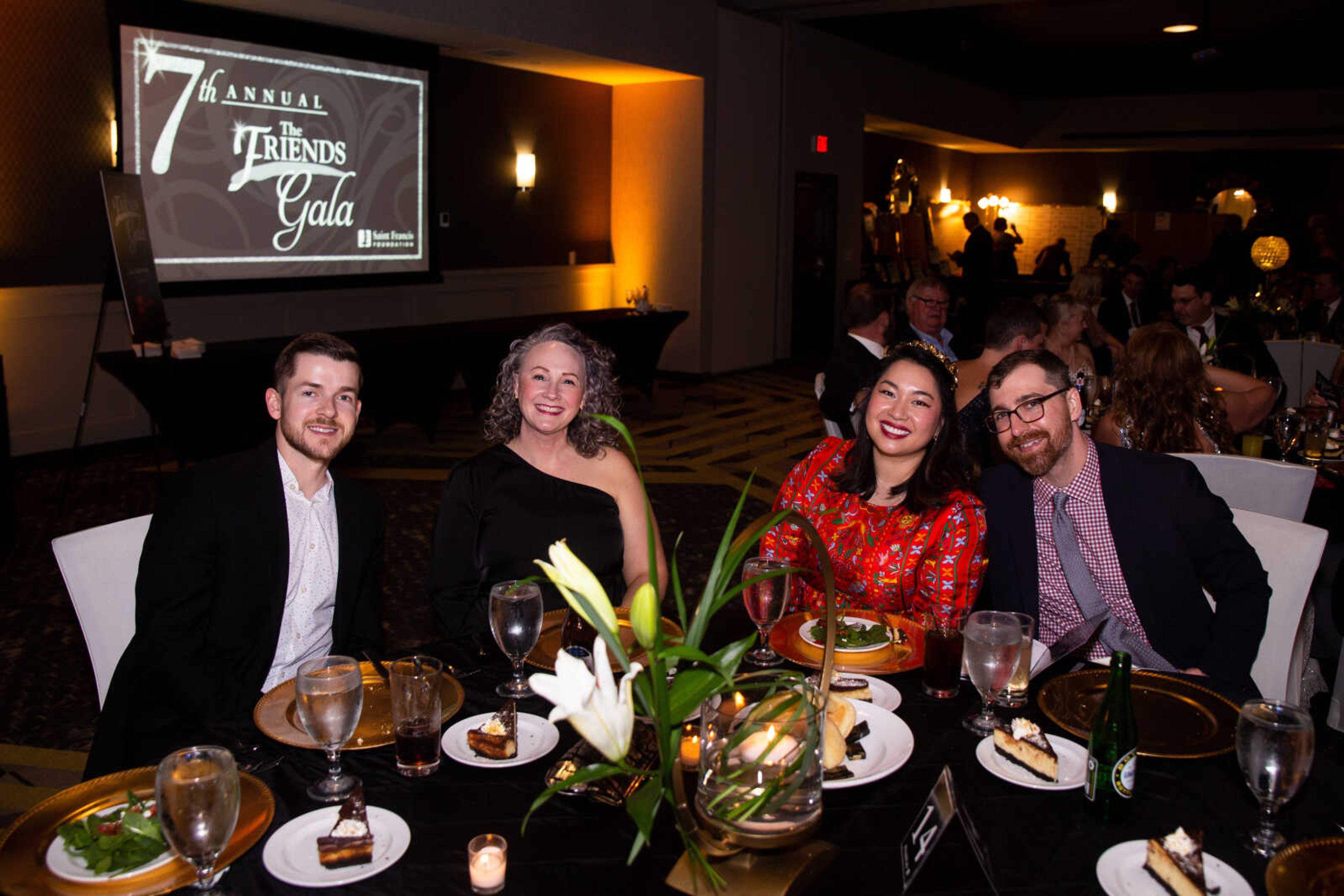 Aaron Dodge, Kandra Voshage and An and Harlen Lawrence sit together at the gala.