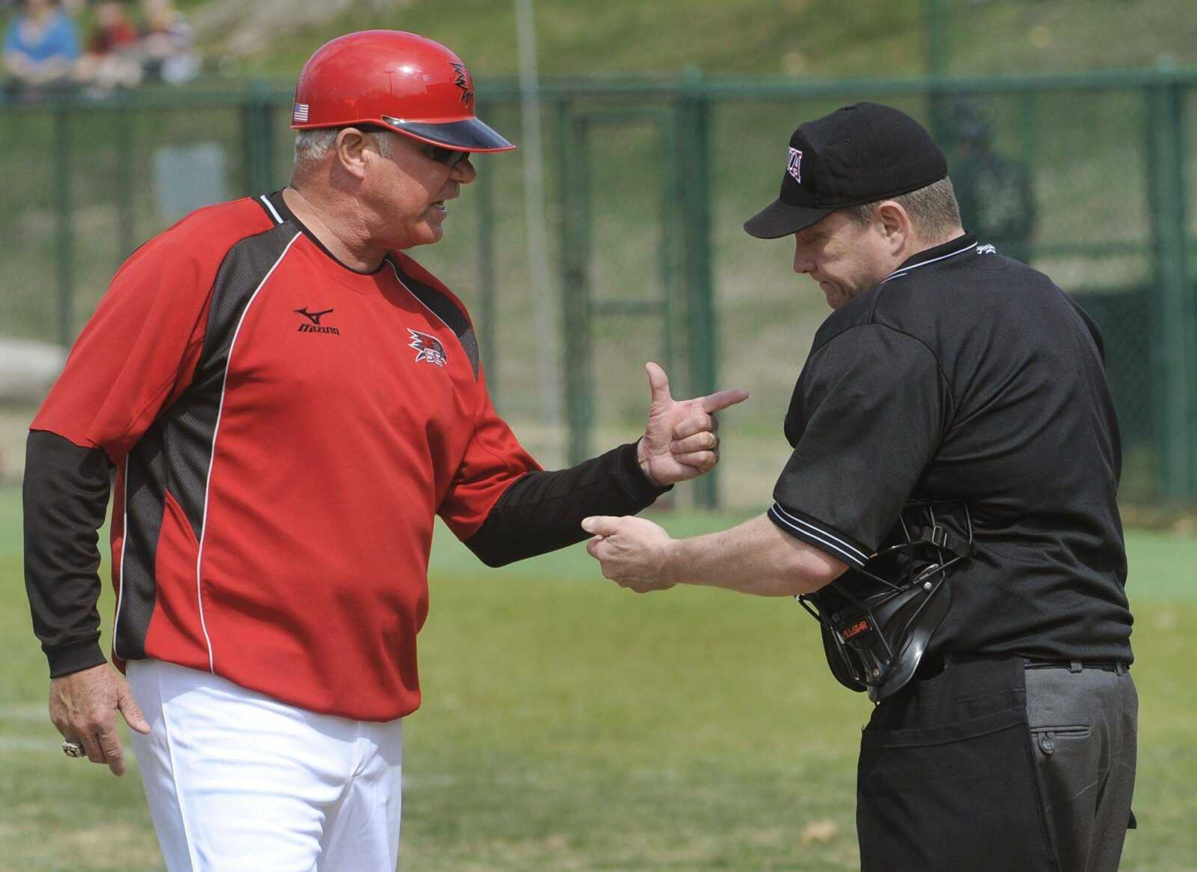 Southeast Missouri State coach Mark Hogan makes a point with umpire Darryl Myers during the fifth inning Sunday at Capaha Field. Hogan contested a call on Southeast base runner Casey Jones (bottom photos), who was thrown out at home when he tried to score from first on a double. (Fred Lynch)