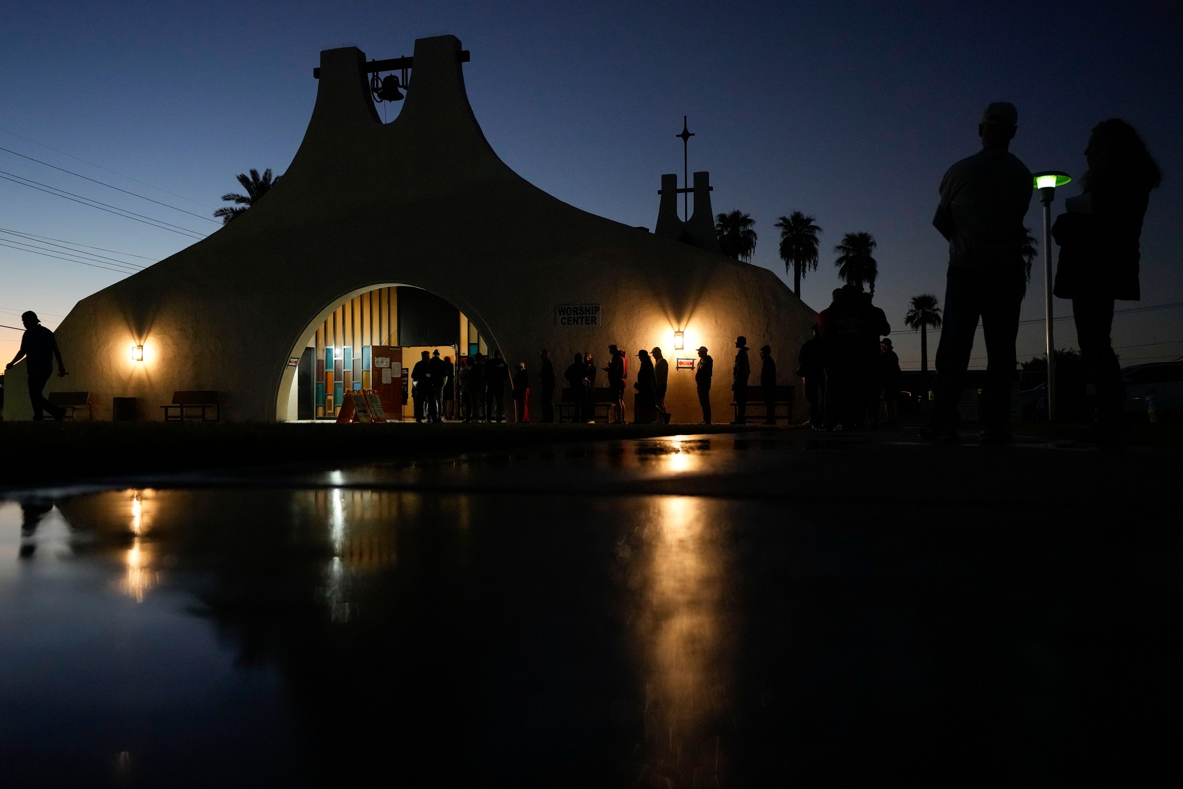 Voters stand in line outside a polling place at Madison Church, Tuesday, Nov. 5, 2024, in Phoenix, Ariz. (AP Photo/Matt York)