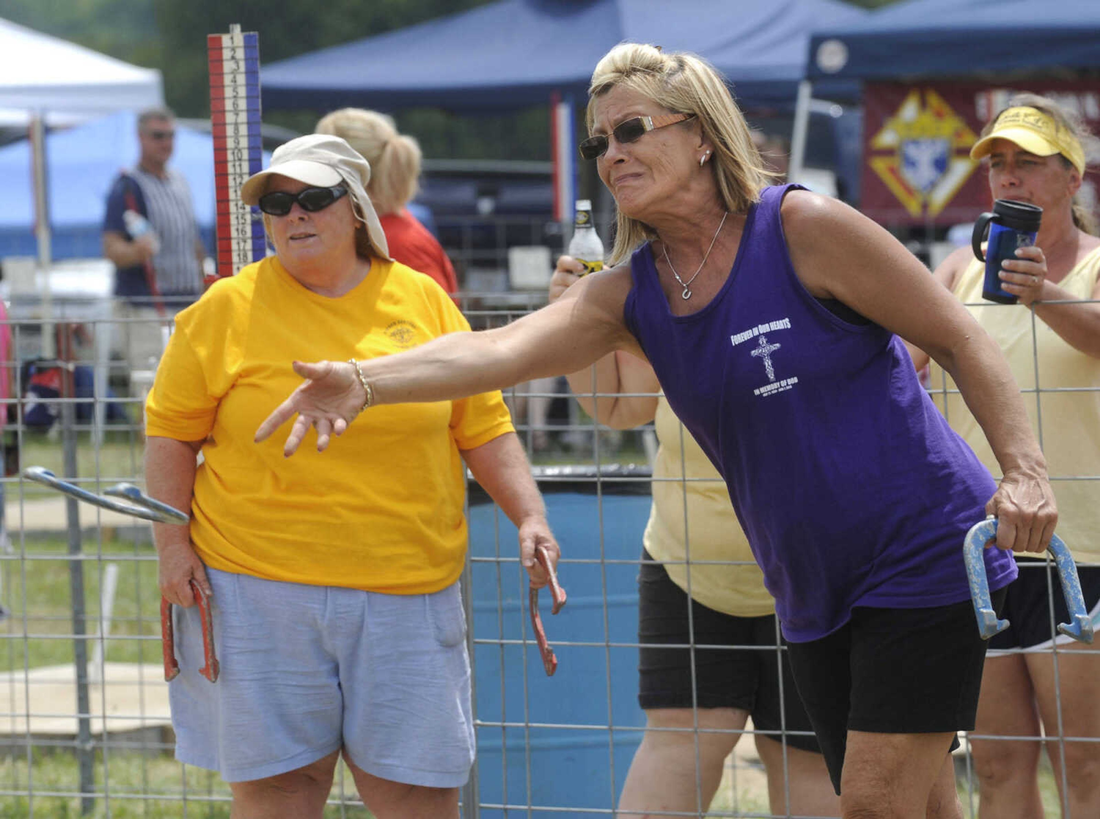 Lisa Willett of Hannibal, Mo. throws a horseshoe as Peggy Nenninger of Warrenton, Mo. waits her turn Sunday, Aug. 18, 2013 at the 33rd annual Knights of Columbus State Horseshoe Tournament in Jackson.