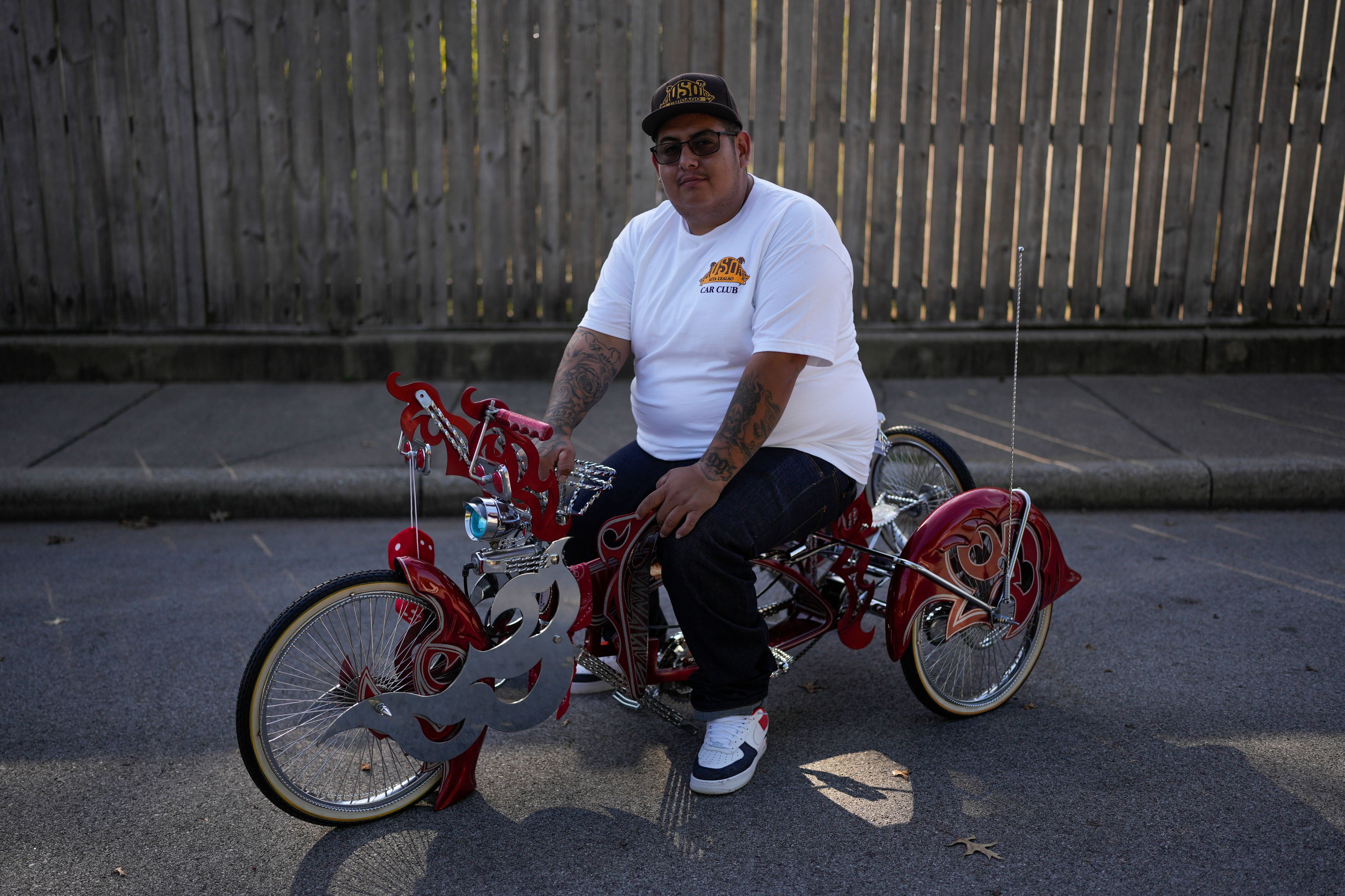 Luis Martinez, 29, a member of the Uso Chicago Car Club, sits on his custom-built lowrider bike Saturday, Sept. 21, 2024, in Mishawaka, Ind. (AP Photo/Erin Hooley)