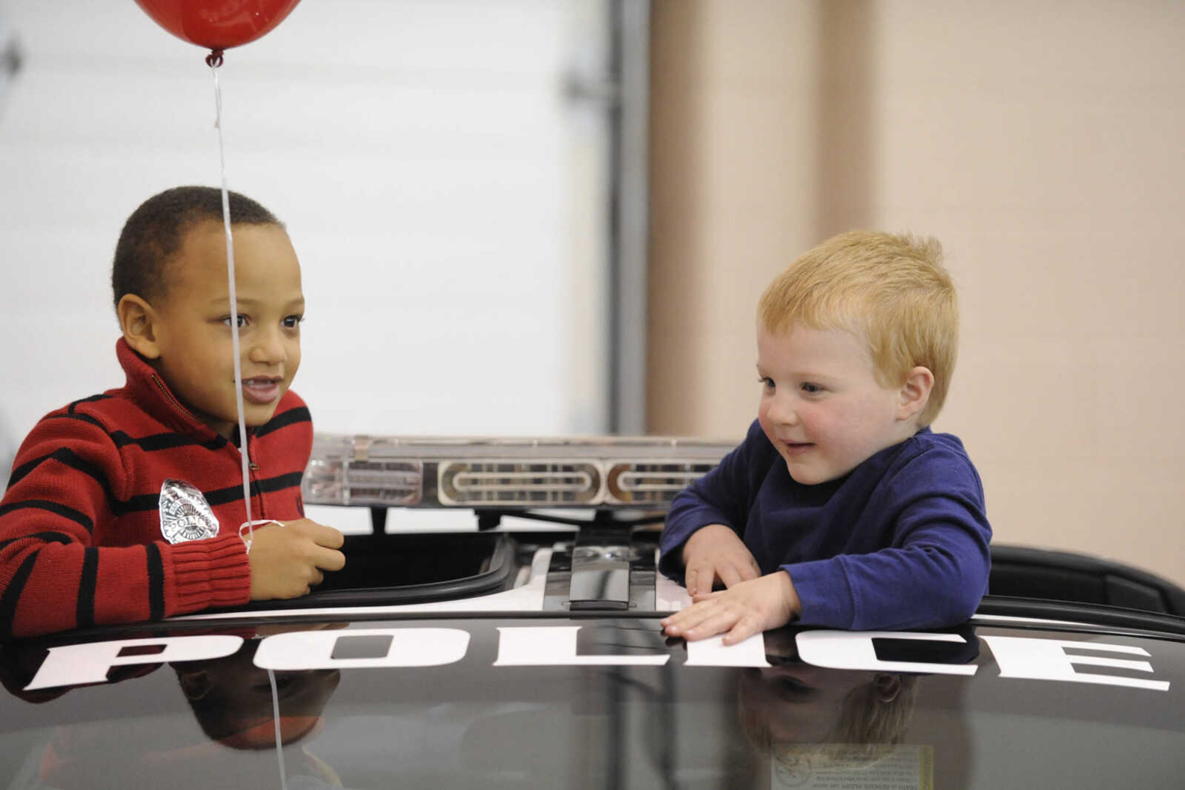 GLENN LANDBERG ~ glandberg@semissourian.com

Aidyn Jennings and Wyatt Hill check out a police car during breakfast with Santa Saturday, Dec. 13, 2014 at the Osage Centre.