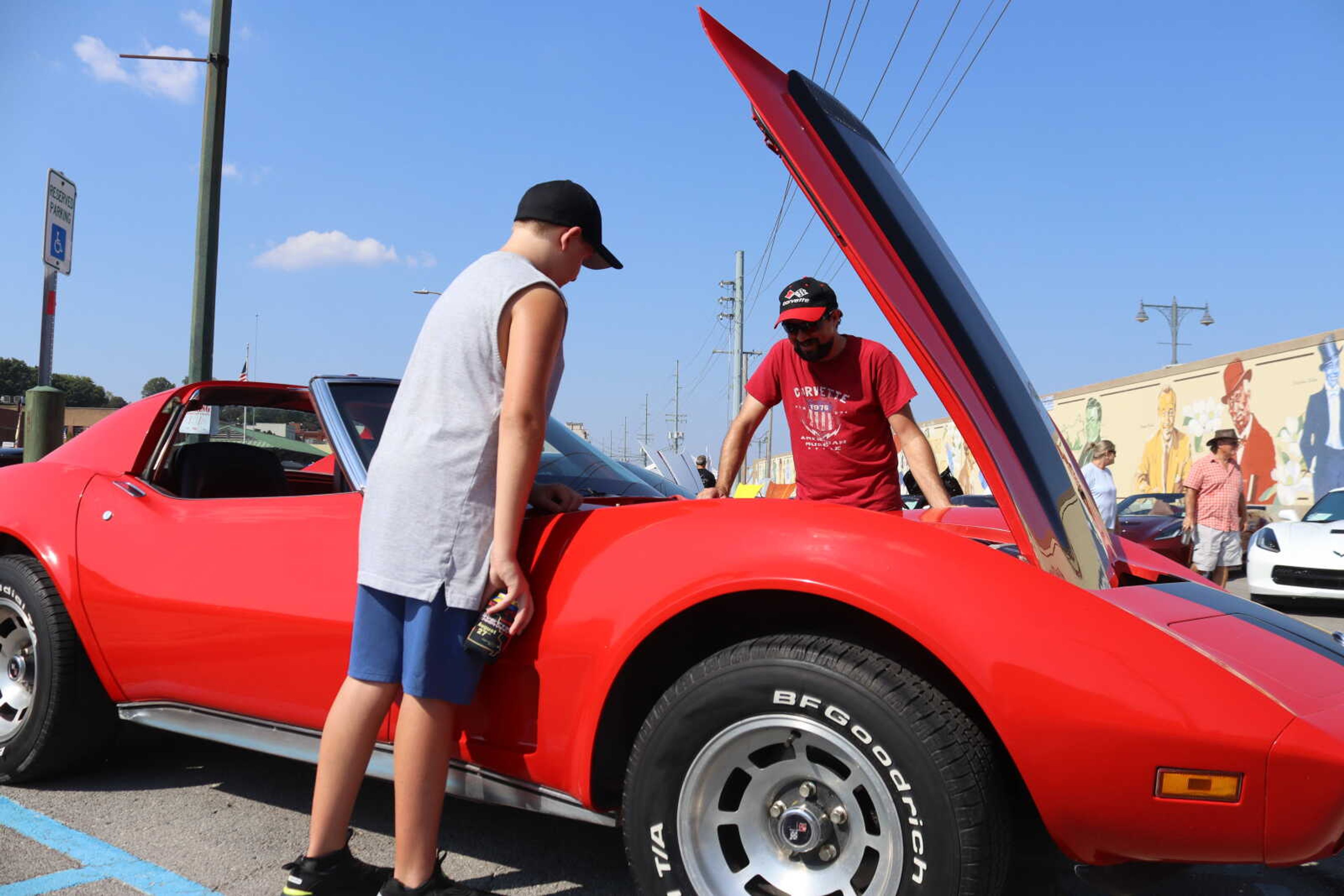 Micheal Ensey and his uncle, Brandon Ensey, look at the inside of Brandon's Corvette.