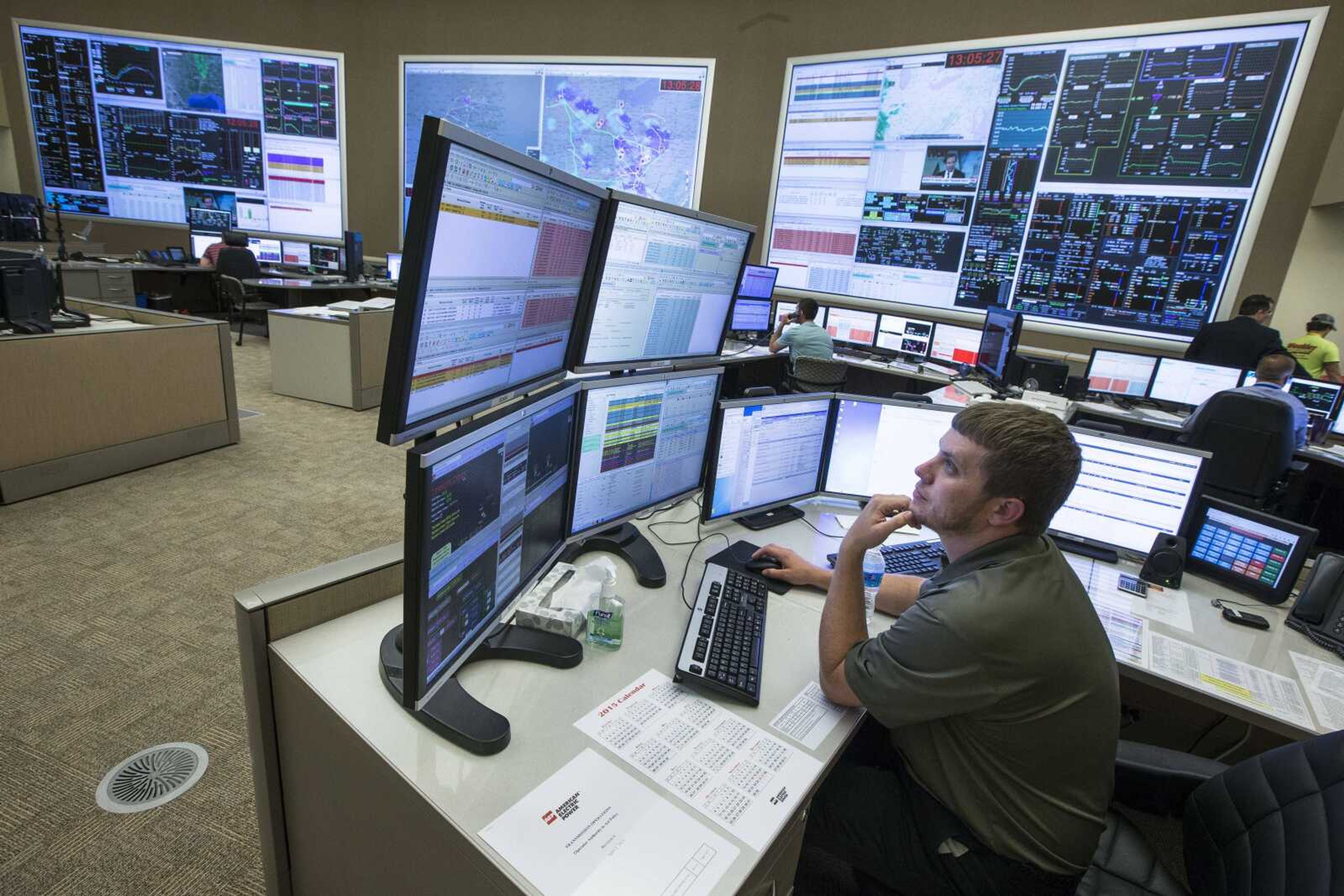 System control center operator Ryan Cox sits at his computer workstation May 20 at an AEP Transmission Operations Center in New Albany, Ohio. Many of the substations and equipment that move power across the U.S. are decrepit and never were built with network security in mind. (John Minchillo ~ Associated Press)