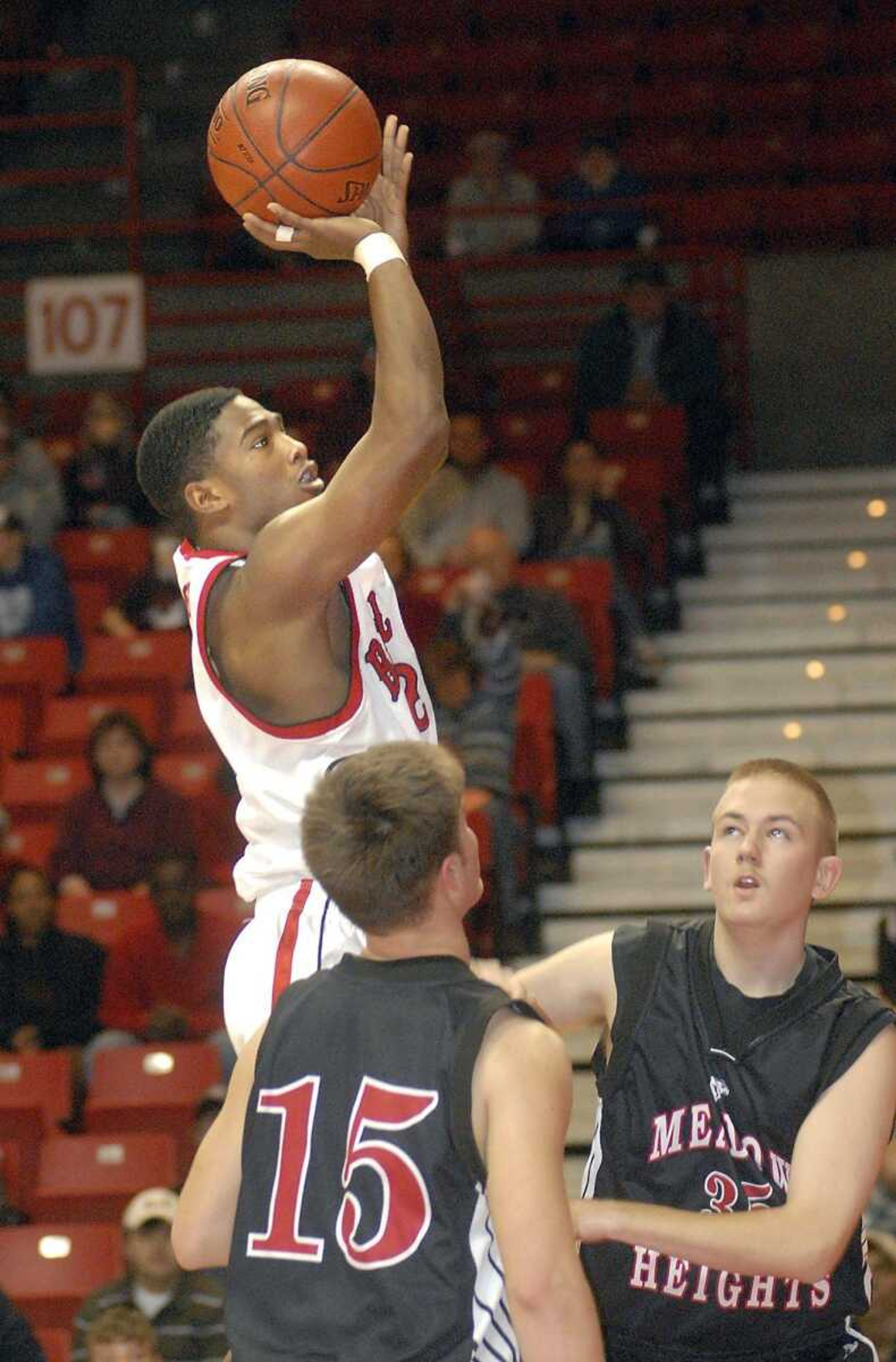 Bell City's Austin Segers shot over Meadow Heights' Ethan Mitchell (15) and Derek Bess in the second quarter Tuesday at the Southeast Missourian Christmas Tournament. (AARON EISENHAUER ~ photos@semissourian.com)