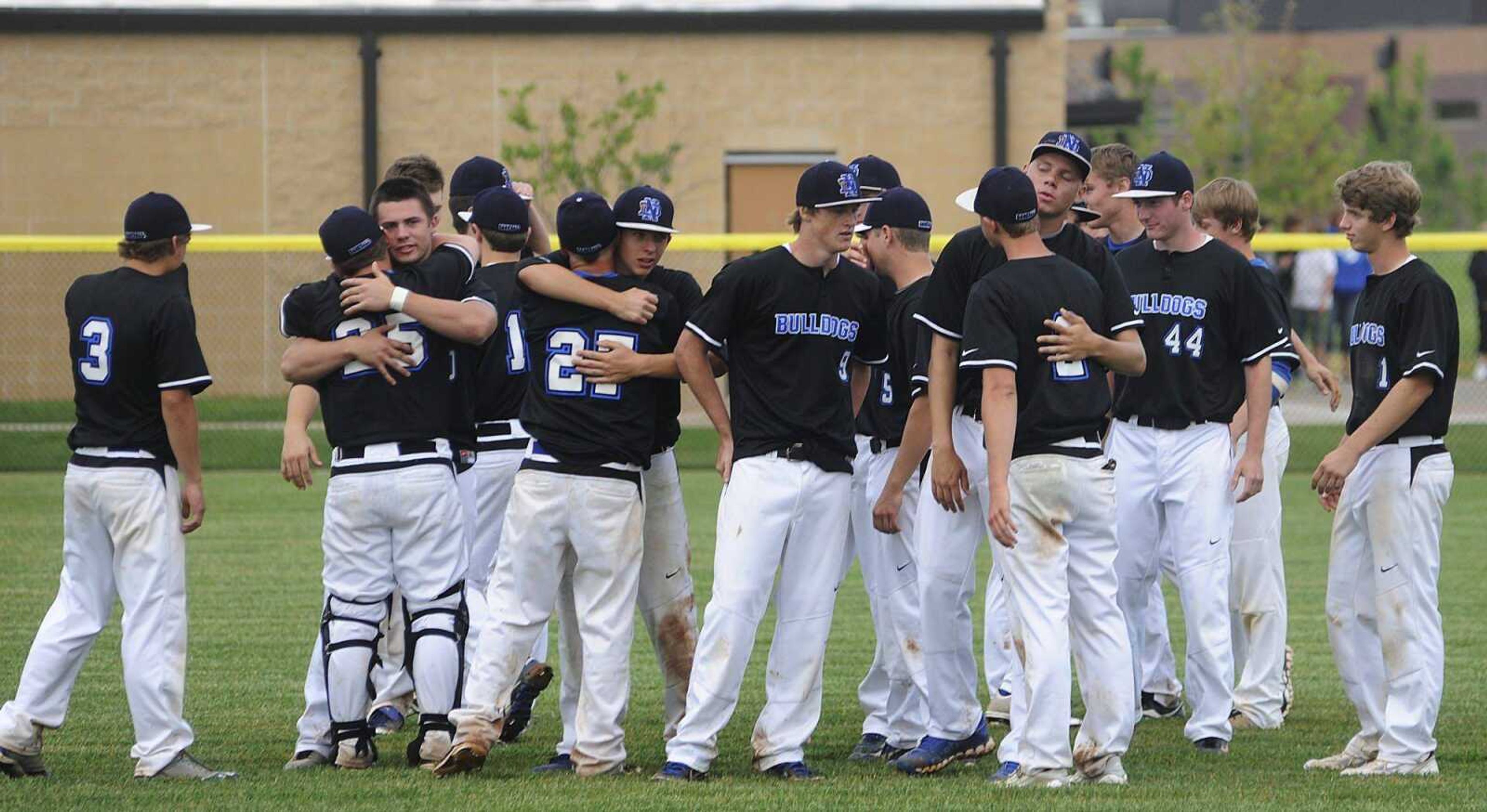 Notre Dame players embrace after the Bulldogs&#8217; 7-5 loss to Westminster in the Class 4 quarterfinals Thursday in Town and Country, Mo. A photo gallery from the game can be viewed at semboall.com. (ADAM VOGLER)