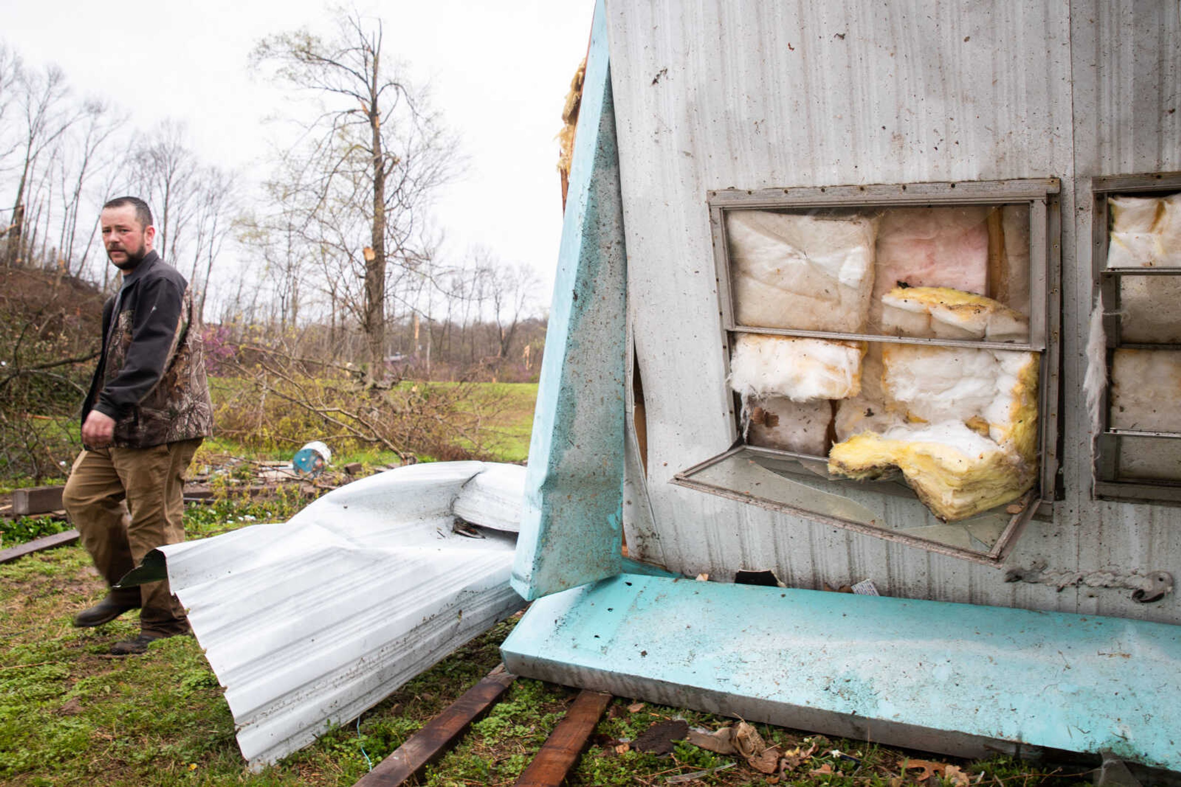 Matt Torbet, a&nbsp;friend of the family of the deceased, walks past the mobile home where five were killed in a tornado on Wednesday, April 5 in Glen Allen.