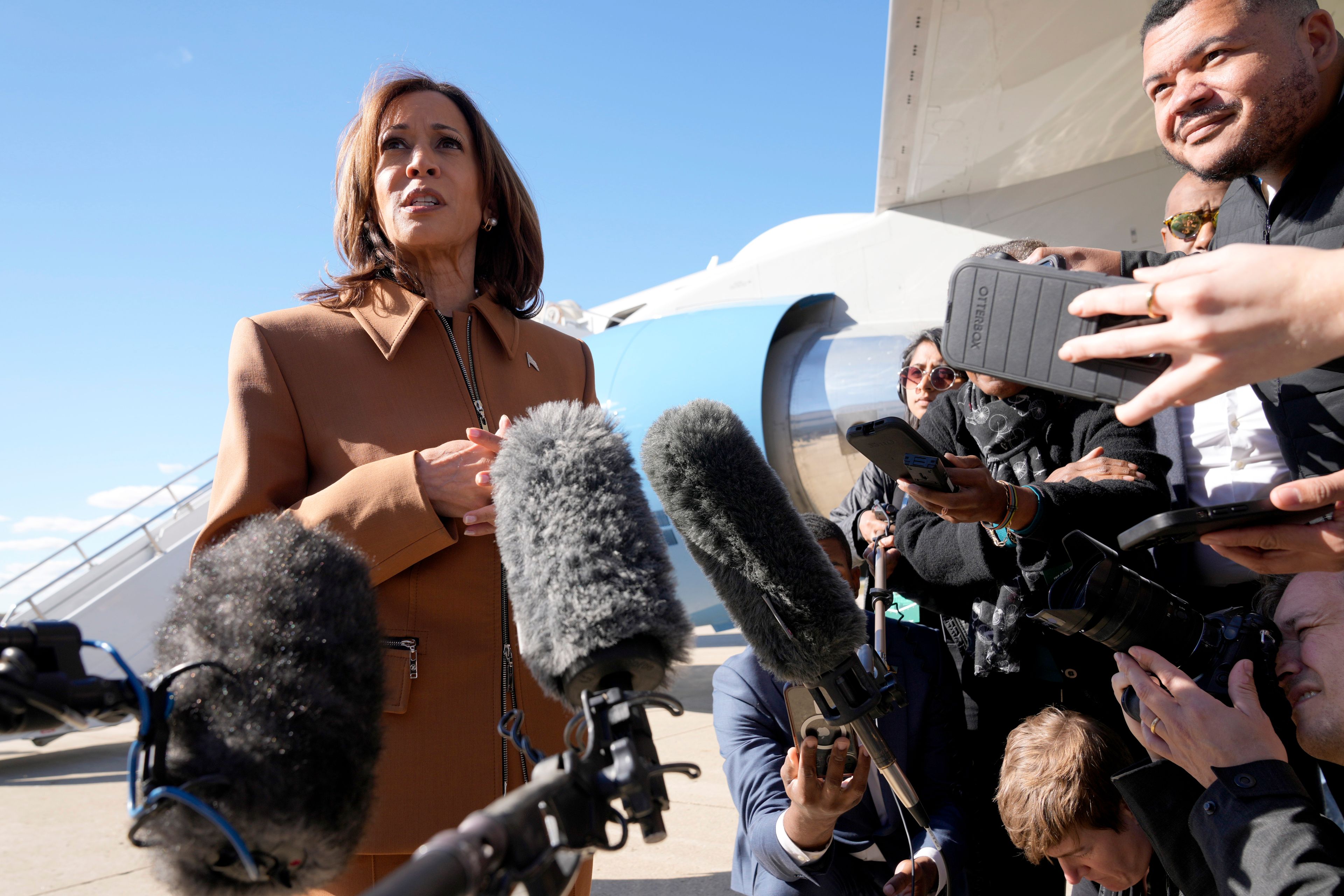 Democratic presidential nominee Vice President Kamala Harris speaks with reporters upon arriving at Kellogg Regional Airport in Battle Creek, Mich., Saturday, Oct. 26, 2024. (AP Photo/Jacquelyn Martin)