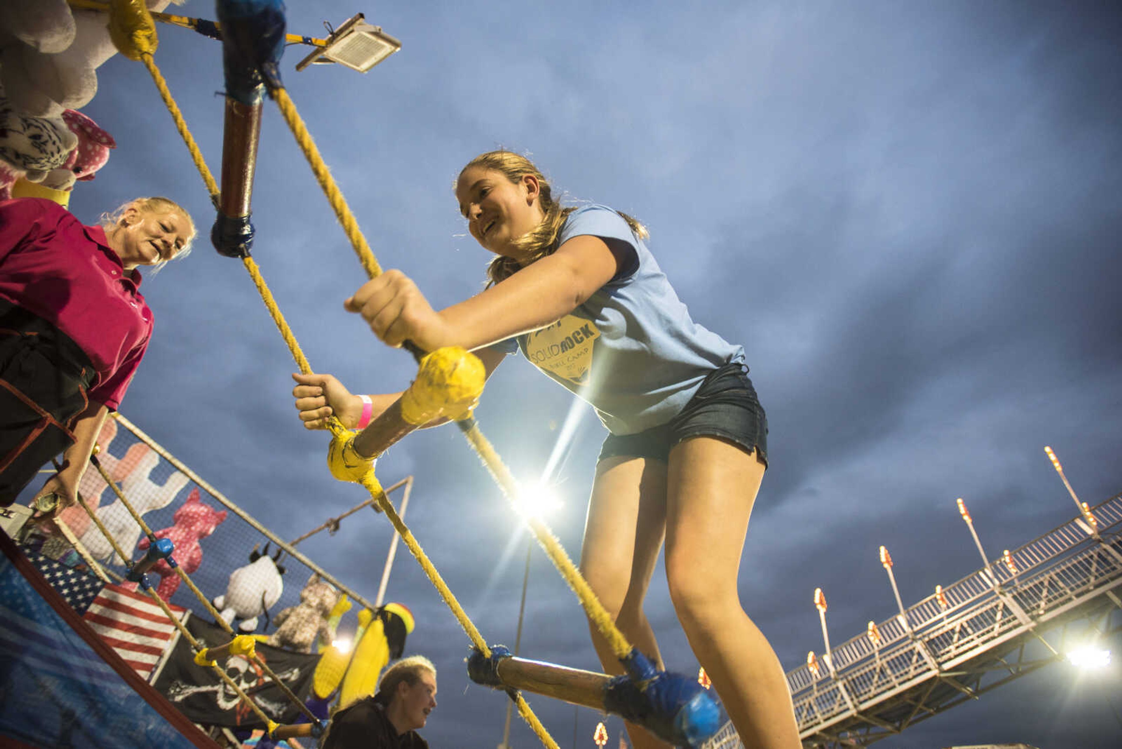 Lauryn Sandin climbs the ladder game with her friend Kara Posch (not pictured) during the SEMO District Fair Wednesday, Sept. 13, 2017 at Arena Park in Cape Girardeau.