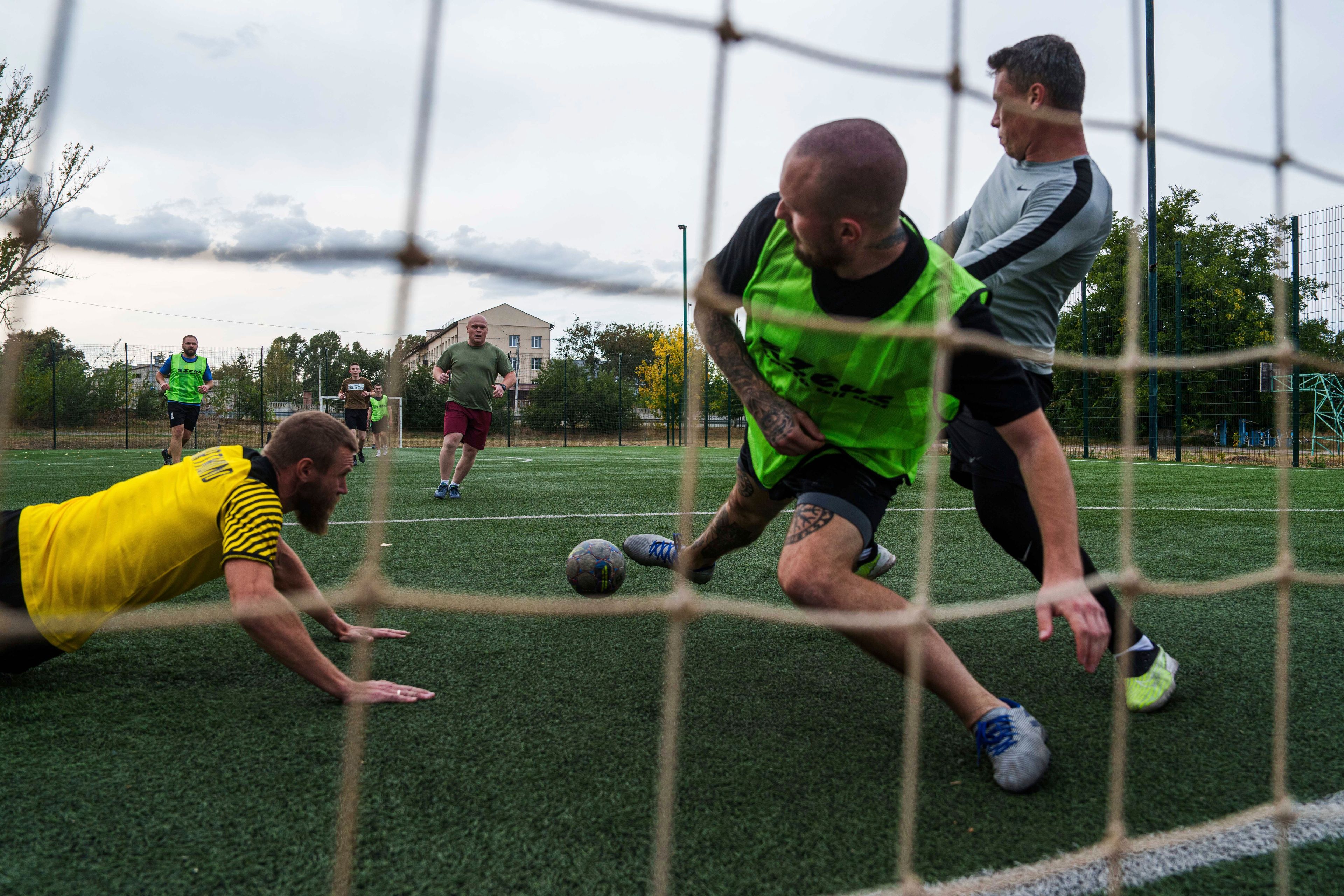 Ukrainian servicemen of 3rd assault brigade play soccer in Izium, Ukraine, Thursday Sept. 26, 2024. (AP Photo/Evgeniy Maloletka)