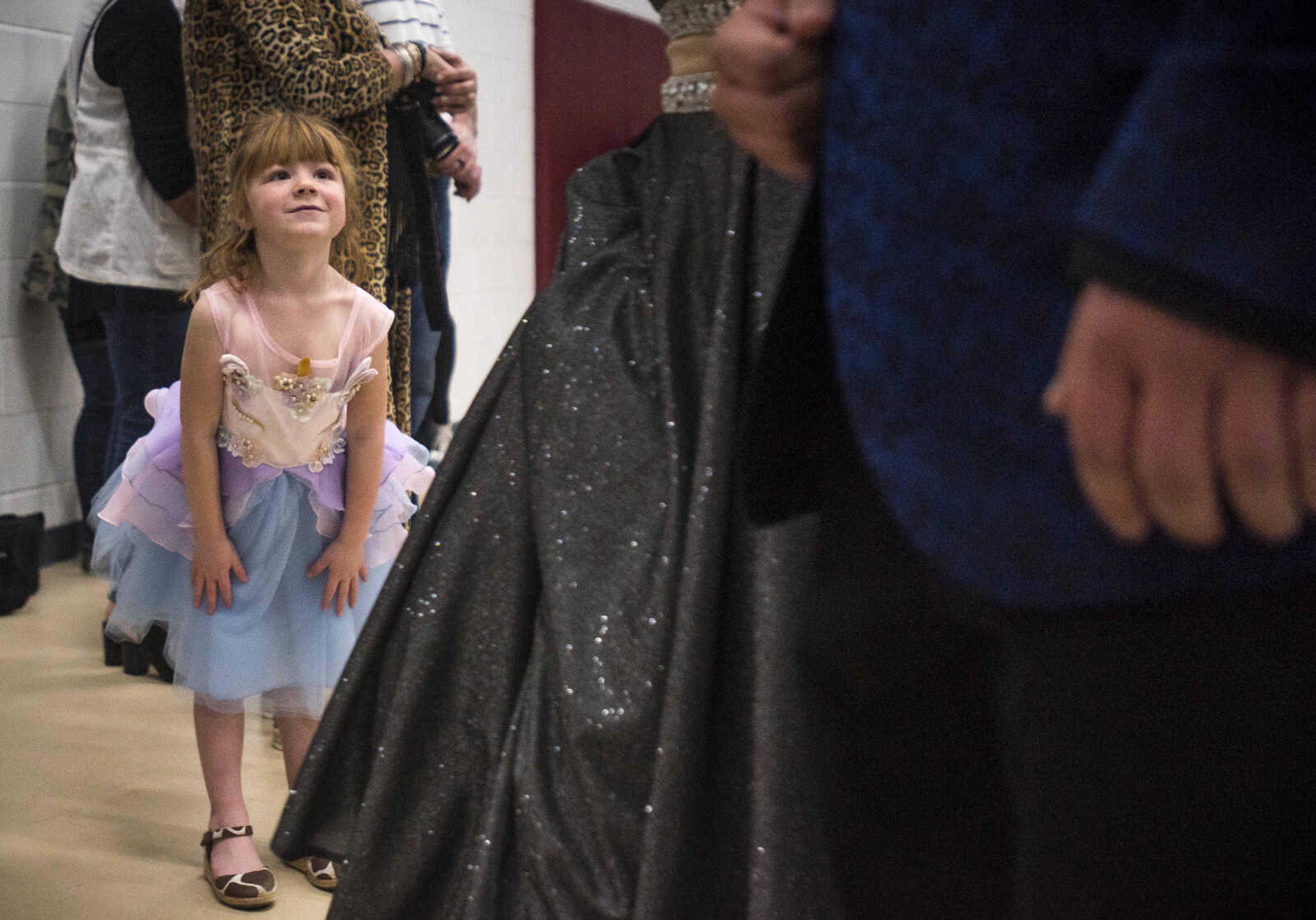 Audrey Oldson, 4, watches Kelly students process through an auxiliary gym before prom Saturday, April 6, 2019, at Kelly High School in Benton. Oldson's mother, Megan Oldson, teaches math at the school and said her daughter dressed especially for the occasion. 
"Oh, she loves this," Megan Oldson said. "We come every year because she loves to see all the princesses."