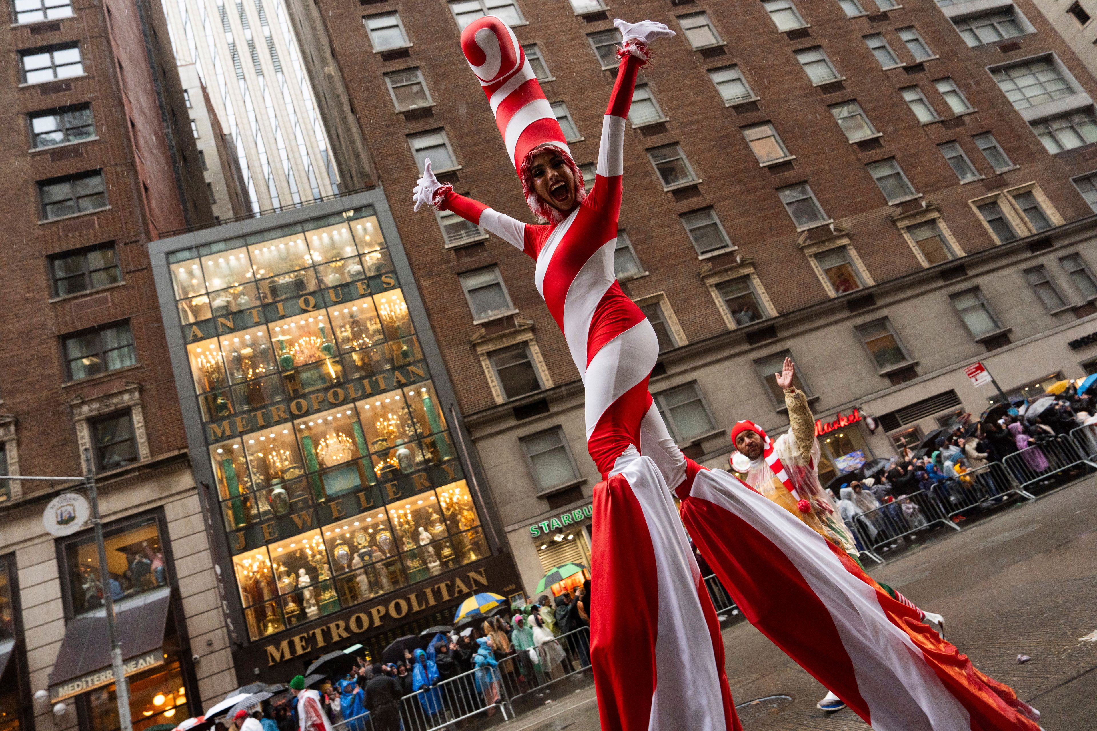 A performer dressed as a candy cane walks down Sixth Avenue during the Macy's Thanksgiving Day Parade, Thursday, Nov. 28, 2024, in New York. (AP Photo/Julia Demaree Nikhinson)