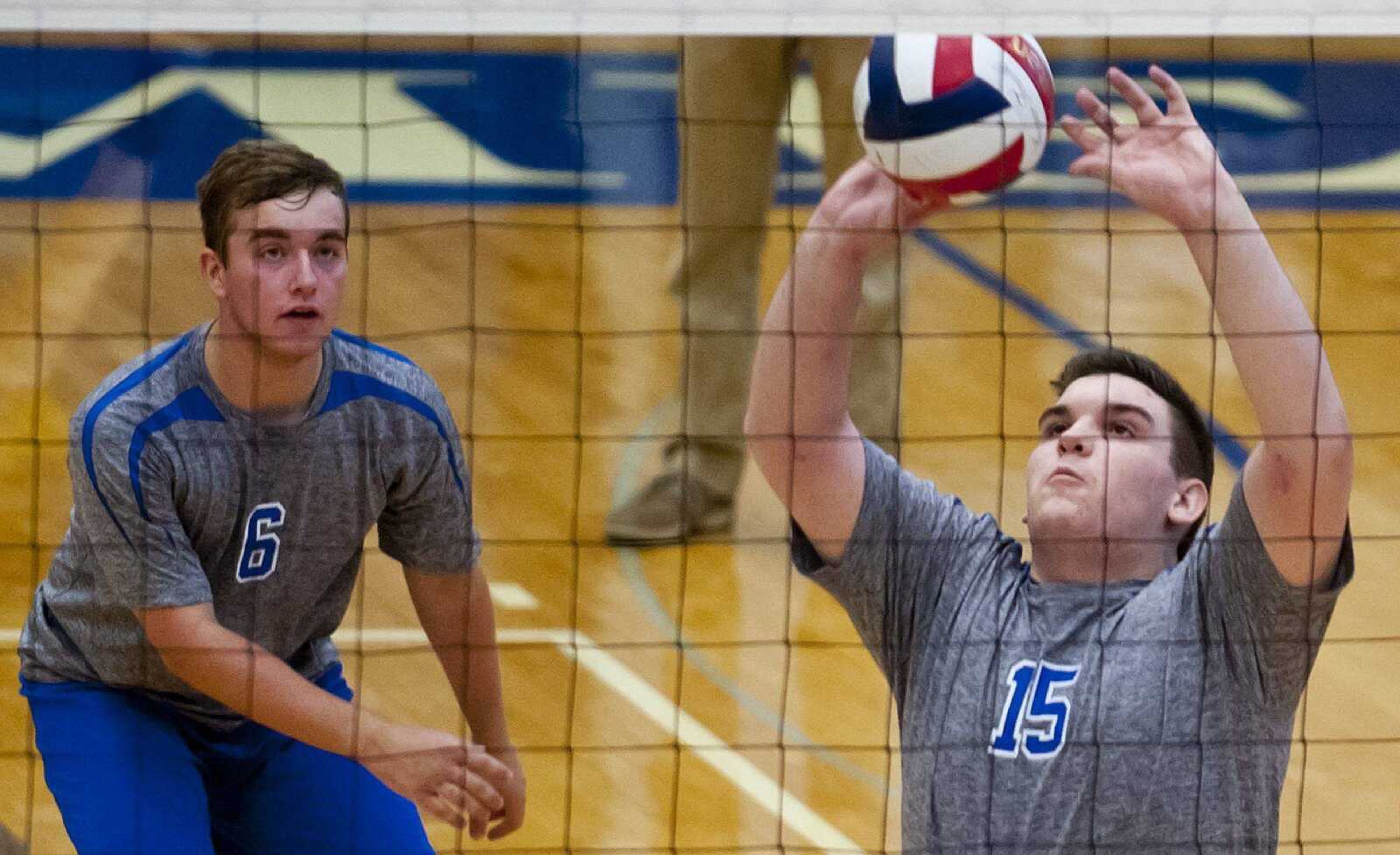 Notre Dame's Rhett Simmons, right, sets for Zach Anderson during the second set of the Bulldogs' 25-15, 25-17 loss to the Lafayette Lancers Friday, April 25, at Notre Dame Regional High School. (Adam Vogler)