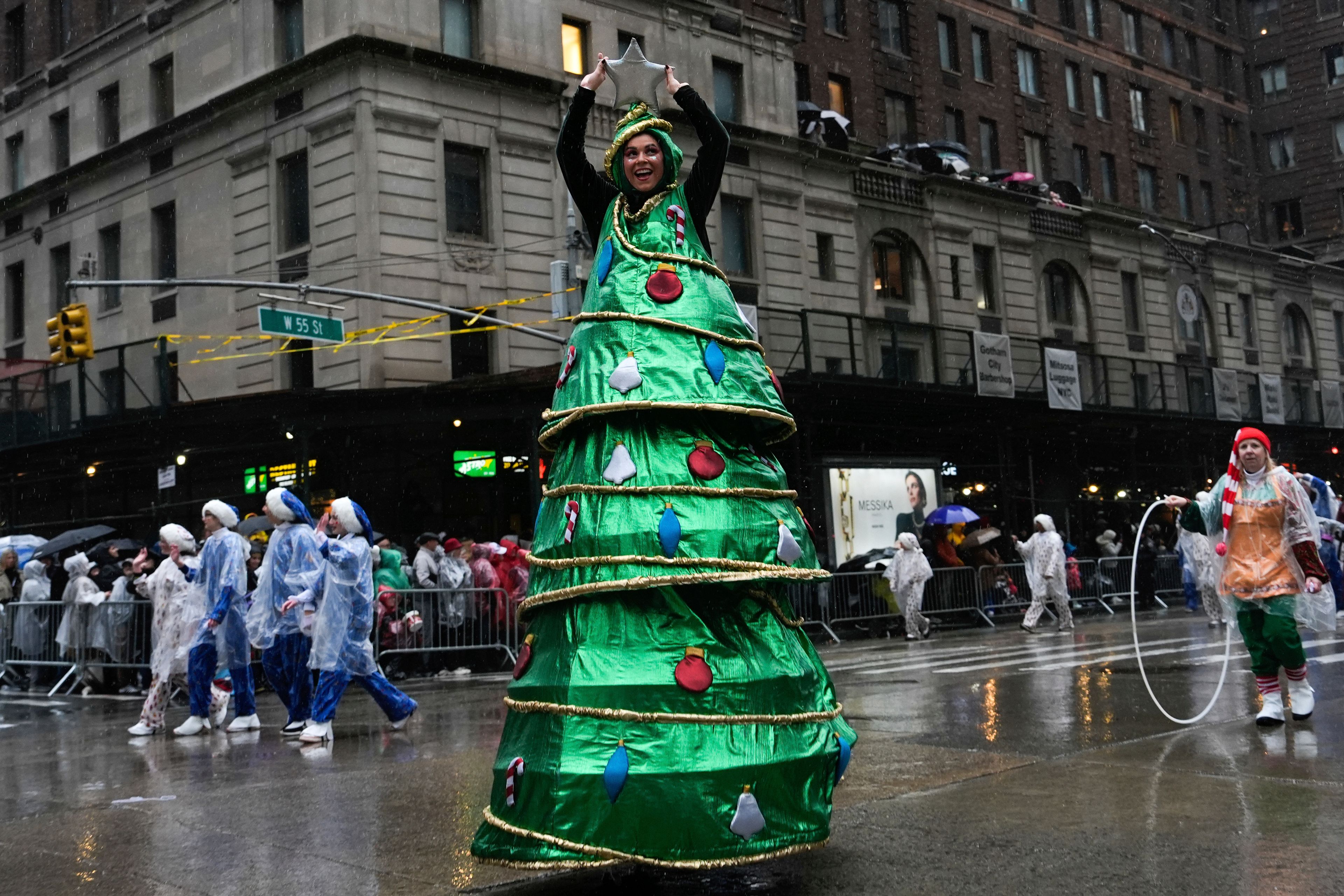 A performer dressed as a Christmas tree walks down Sixth Avenue during the Macy's Thanksgiving Day Parade, Thursday, Nov. 28, 2024, in New York. (AP Photo/Julia Demaree Nikhinson)