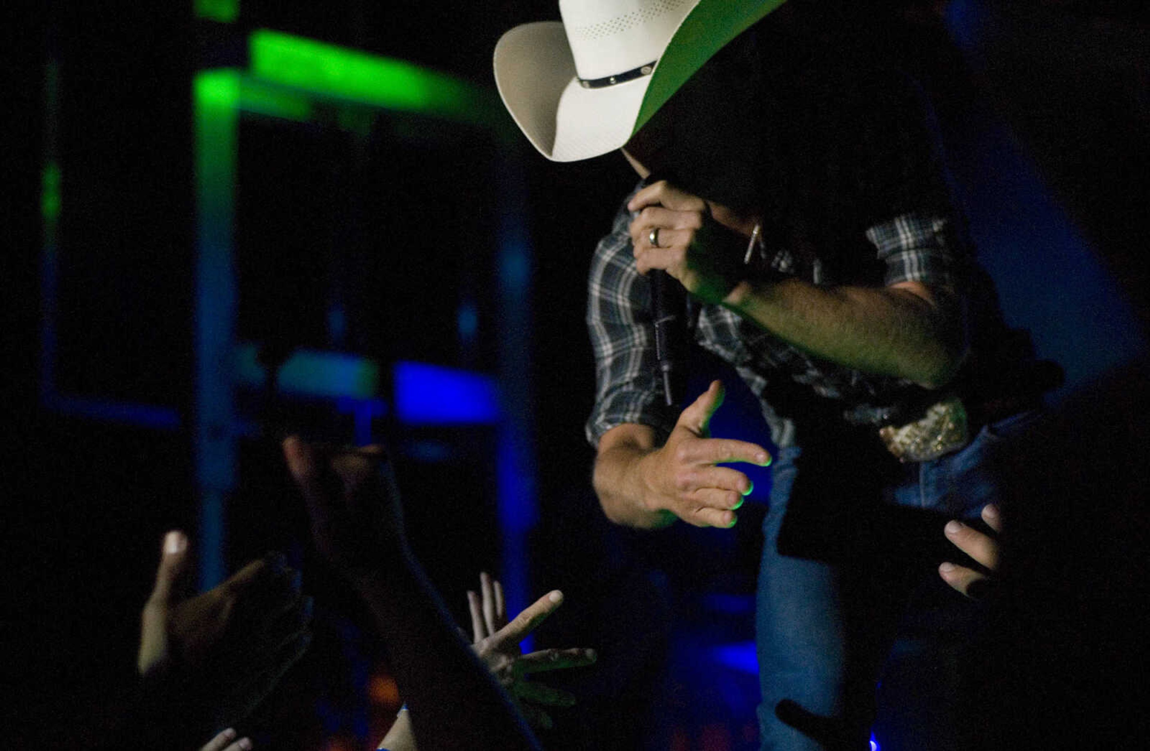 AARON EISENHAUER ~ photos@semissourian.com

Country music star Justin Moore performs for fans on the outdoor stage at Bootheel Harley-Davidson on Friday, July 12, 2013 in Scott City.