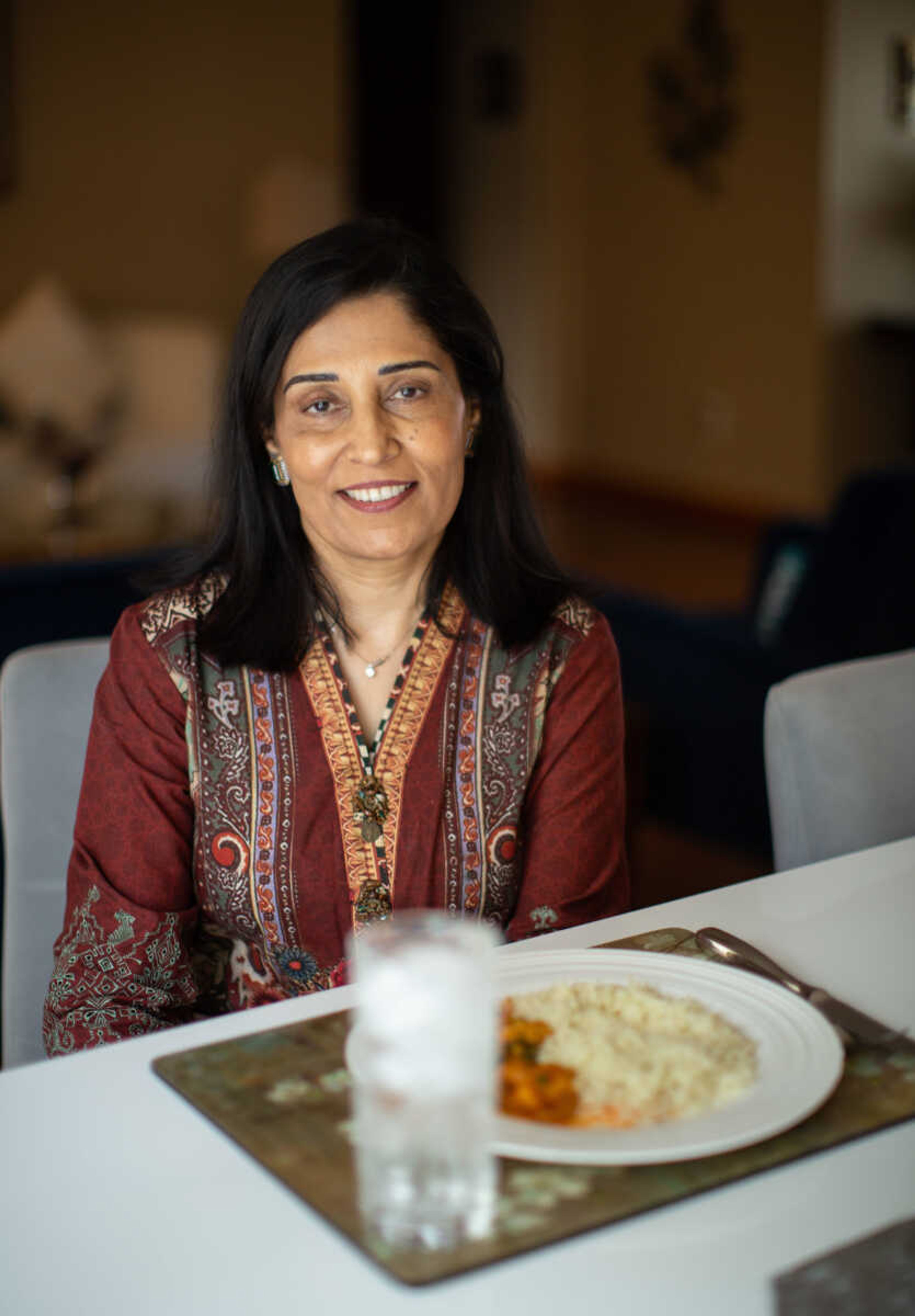 Uzma Aziz sits with a plate of butter chicken masala, a popular dish in Islamabad, Pakistan, where is from. She has lived in Cape Girardeau since 2002 and works as operations director at Southeast Missouri Network Against Sexual Violence (SEMO-NASV).