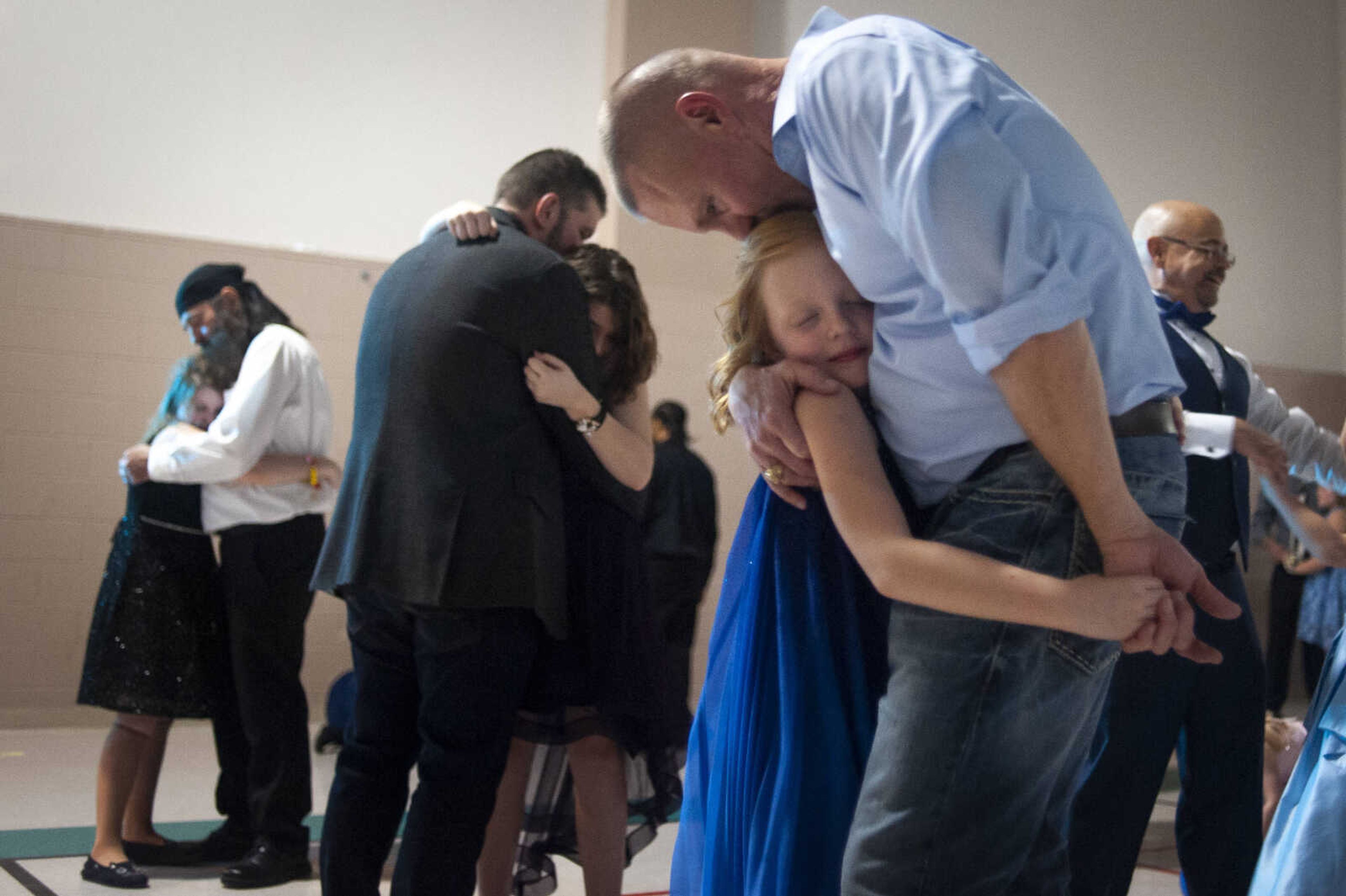 Joda Grace Bess, 7, of Cape Girardeau, receives a kiss from her father David Bess while dancing during the 11th annual Father Daughter Dance on Saturday, Feb. 16, 2019, at the Osage Centre in Cape Girardeau. "It's always a really good time," David said about the dance which he has previously attended with his daughter. The event, with "The Wizard of Oz" as its theme, featured food, music, dancing and wands for participants.