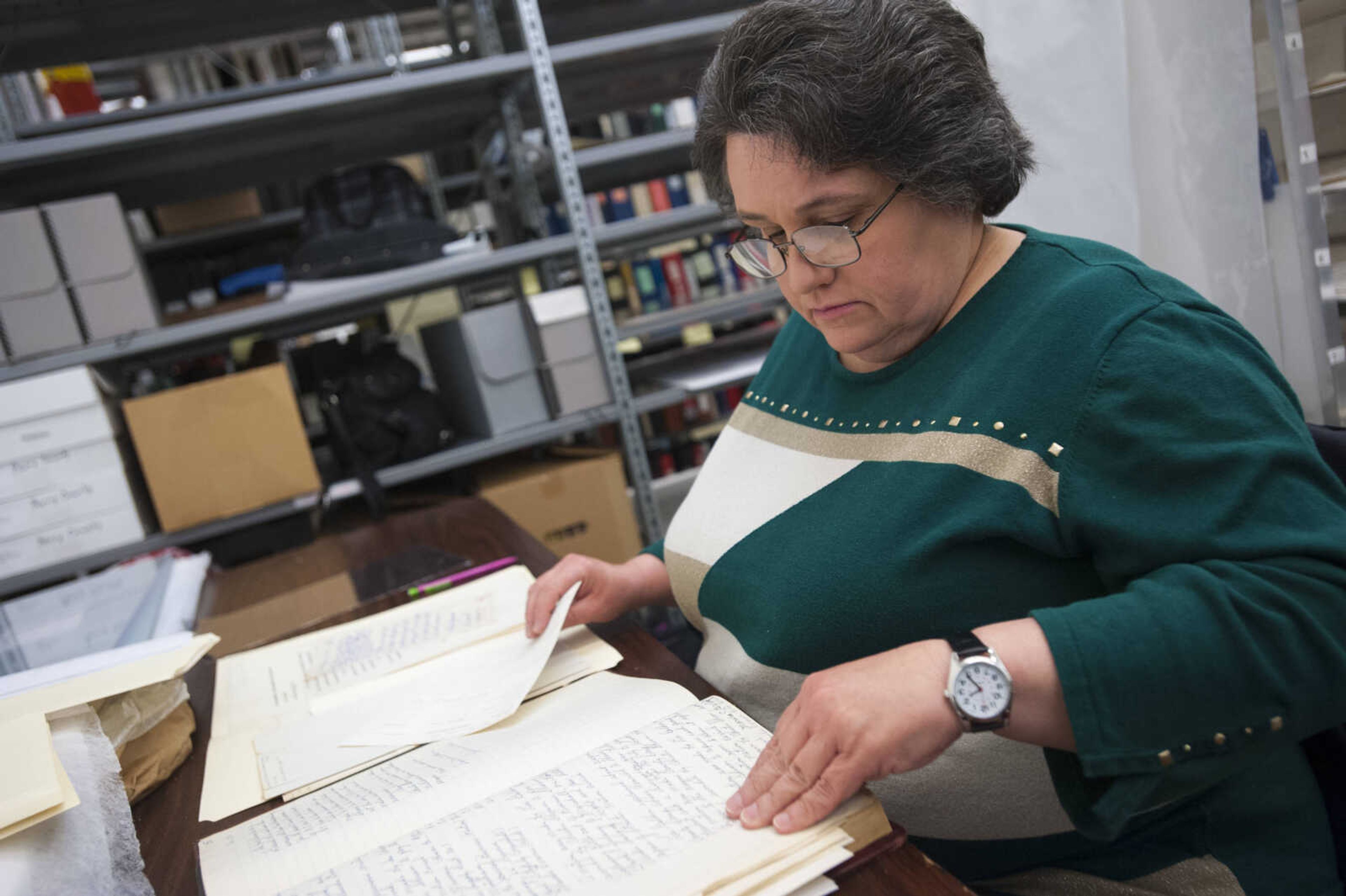 Renae Farris prepares materials from Greenville, Missouri, for digitization Thursday, March 8, 2018, at the Cape Girardeau County Archive Center in Jackson.