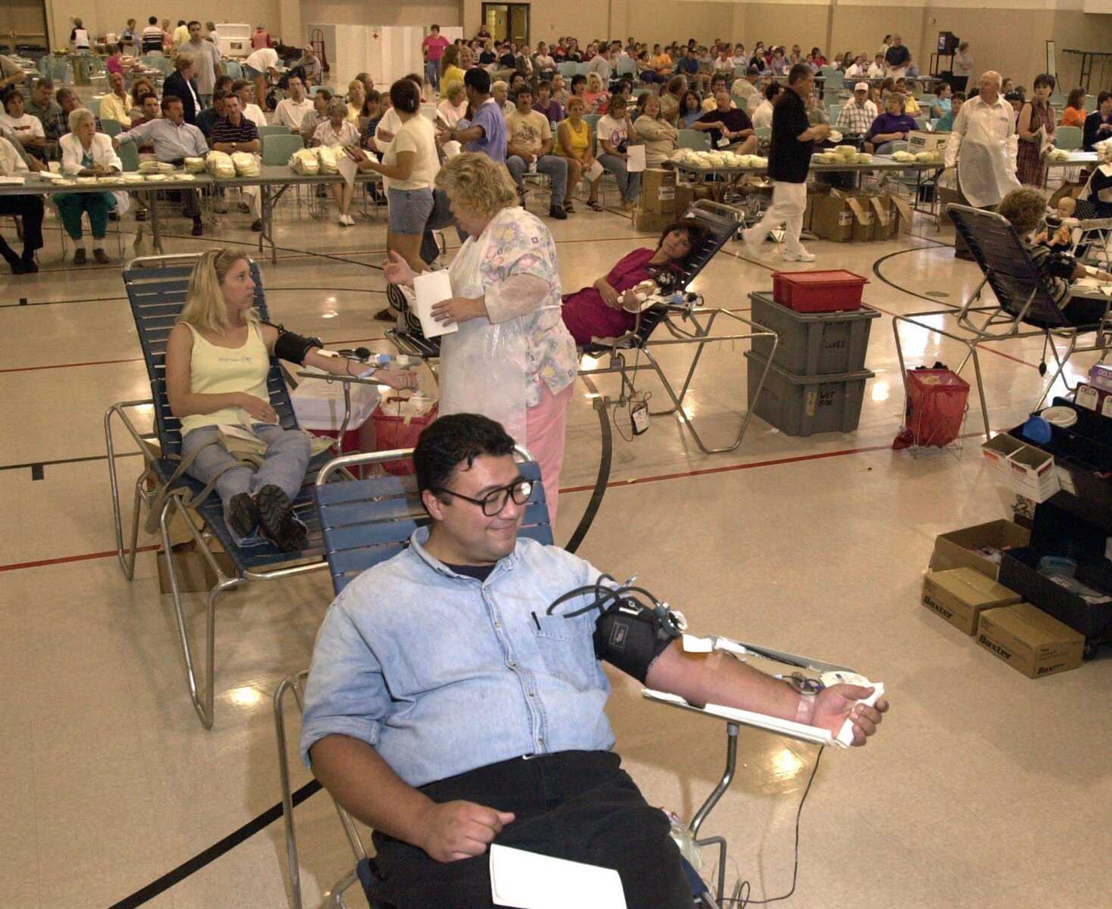 George R. Luna, foreground, waited four hours to donate at the Osage Community Centre in the American Red Cross blood drive Sept. 12, 2001. Luna, a Marine for 13 years, went to the recruiting station to discuss rejoining in the wake of the attacks in New York and Washington. (Southeast Missourian File)