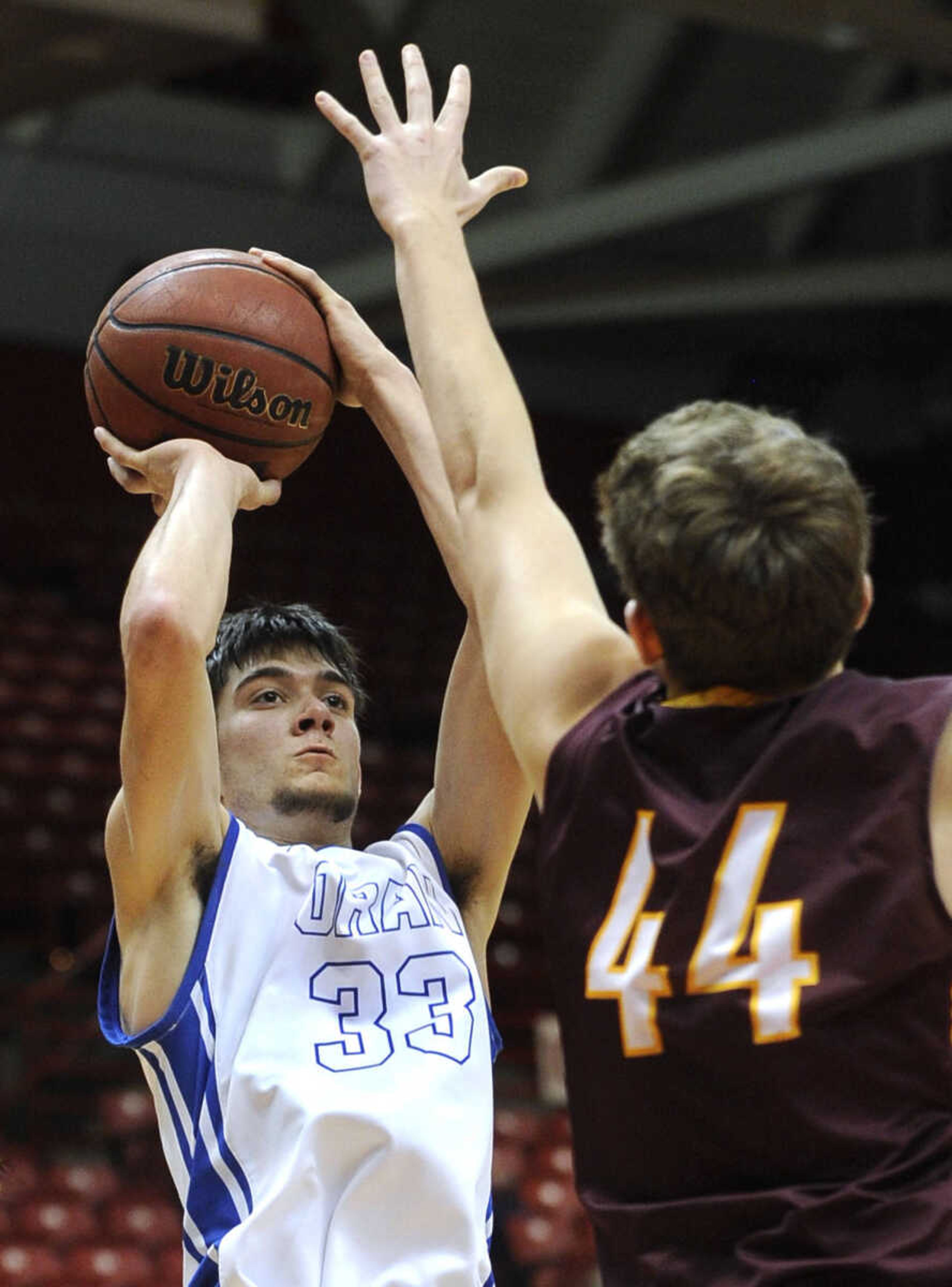 Oran's Hunter Schlosser shoots against Kelly's Conner Dittlinger during the fourth quarter of a consolation semifinal in the Southeast Missourian Christmas Tournament Monday, Dec. 29, 2014 at the Show Me Center. (Fred Lynch)