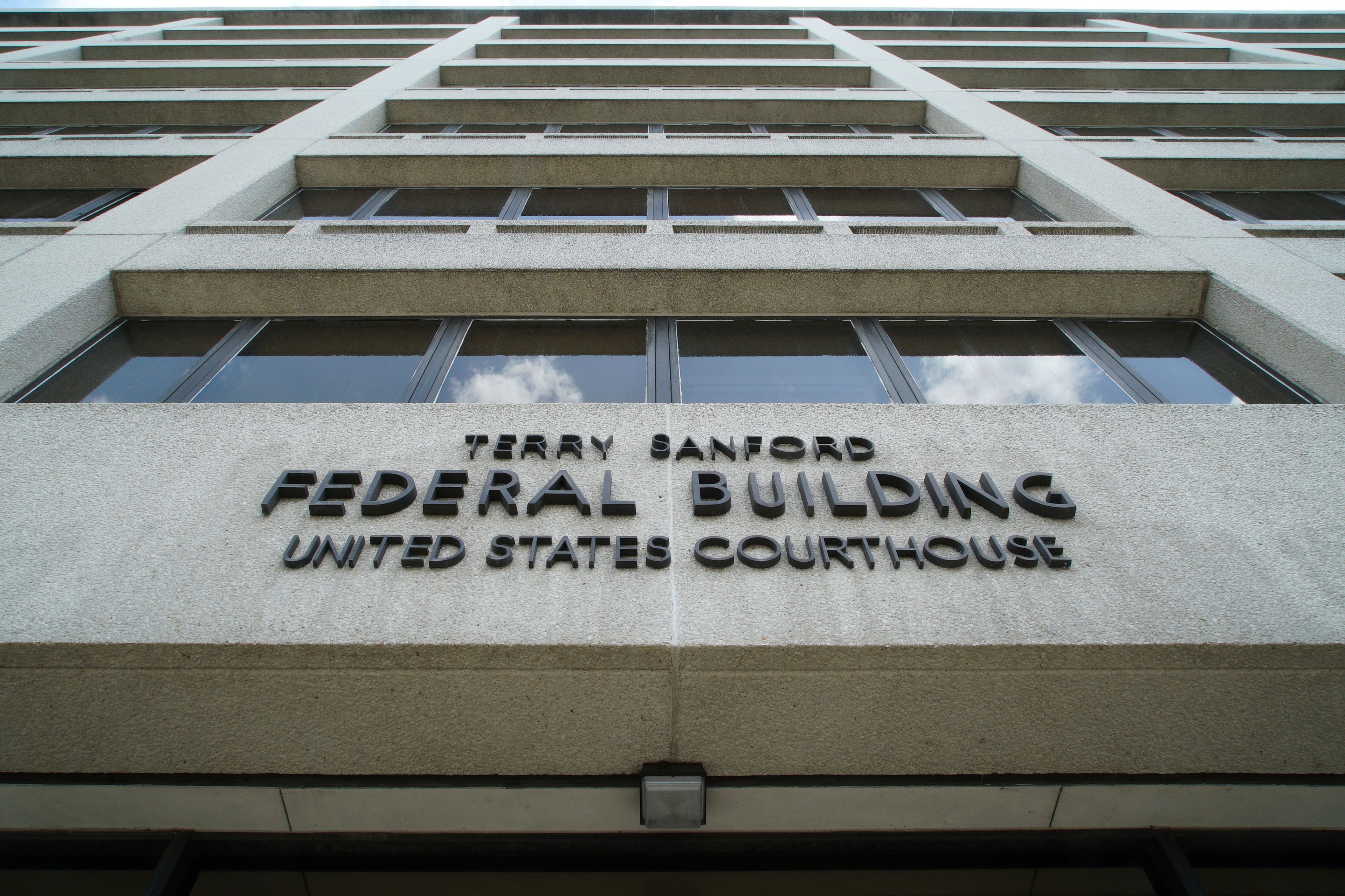 Clouds are reflected in the windows of the federal courthouse in downtown Raleigh, N.C., on Wednesday, July 10, 2024. (AP Photo/Allen G. Breed)