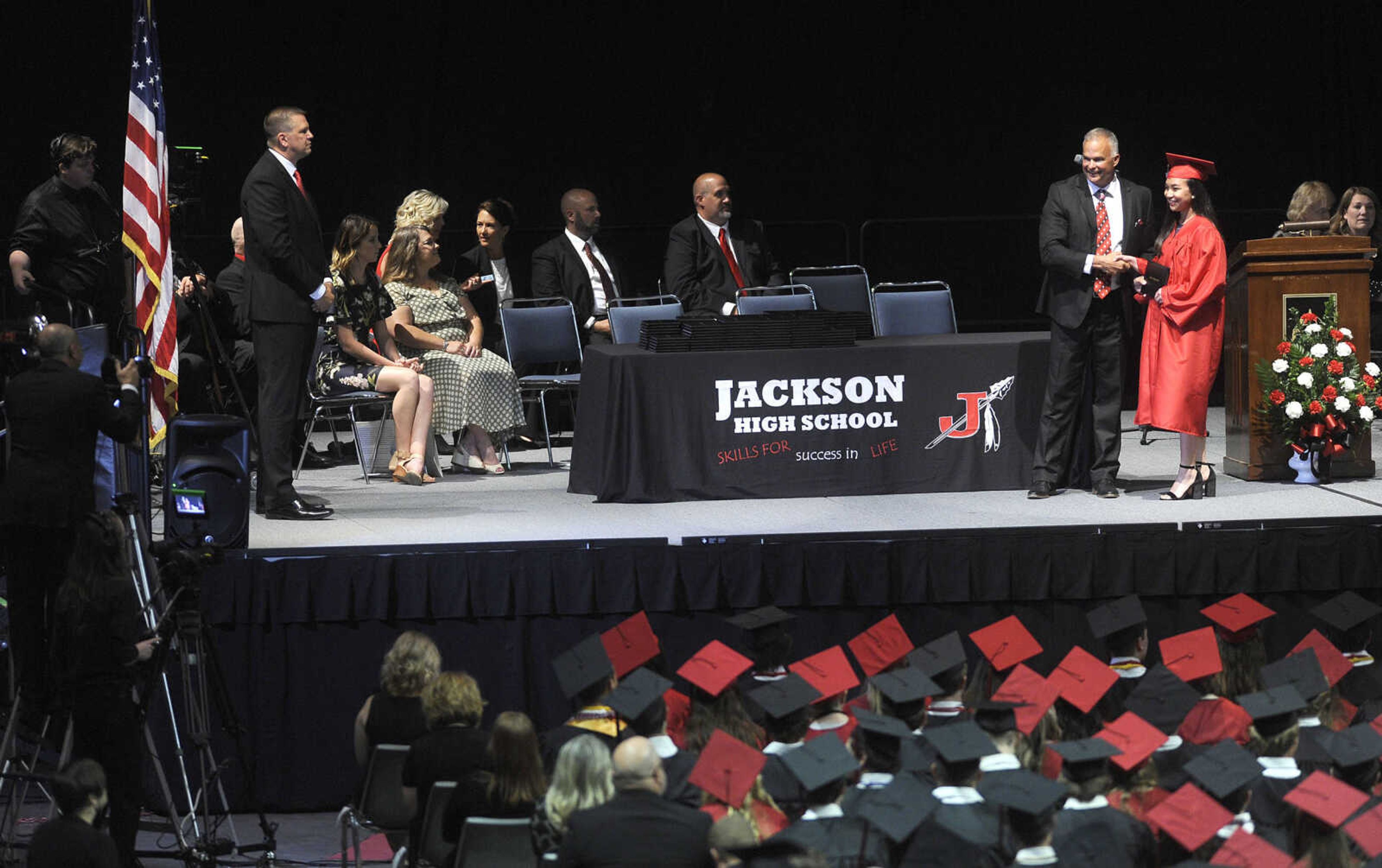 FRED LYNCH ~ flynch@semissourian.com
Angela Loberiza receives a diploma from Jackson Board of Education president Kelly Waller during the Jackson High School commencement Friday, May 18, 2018 at the Show Me Center.