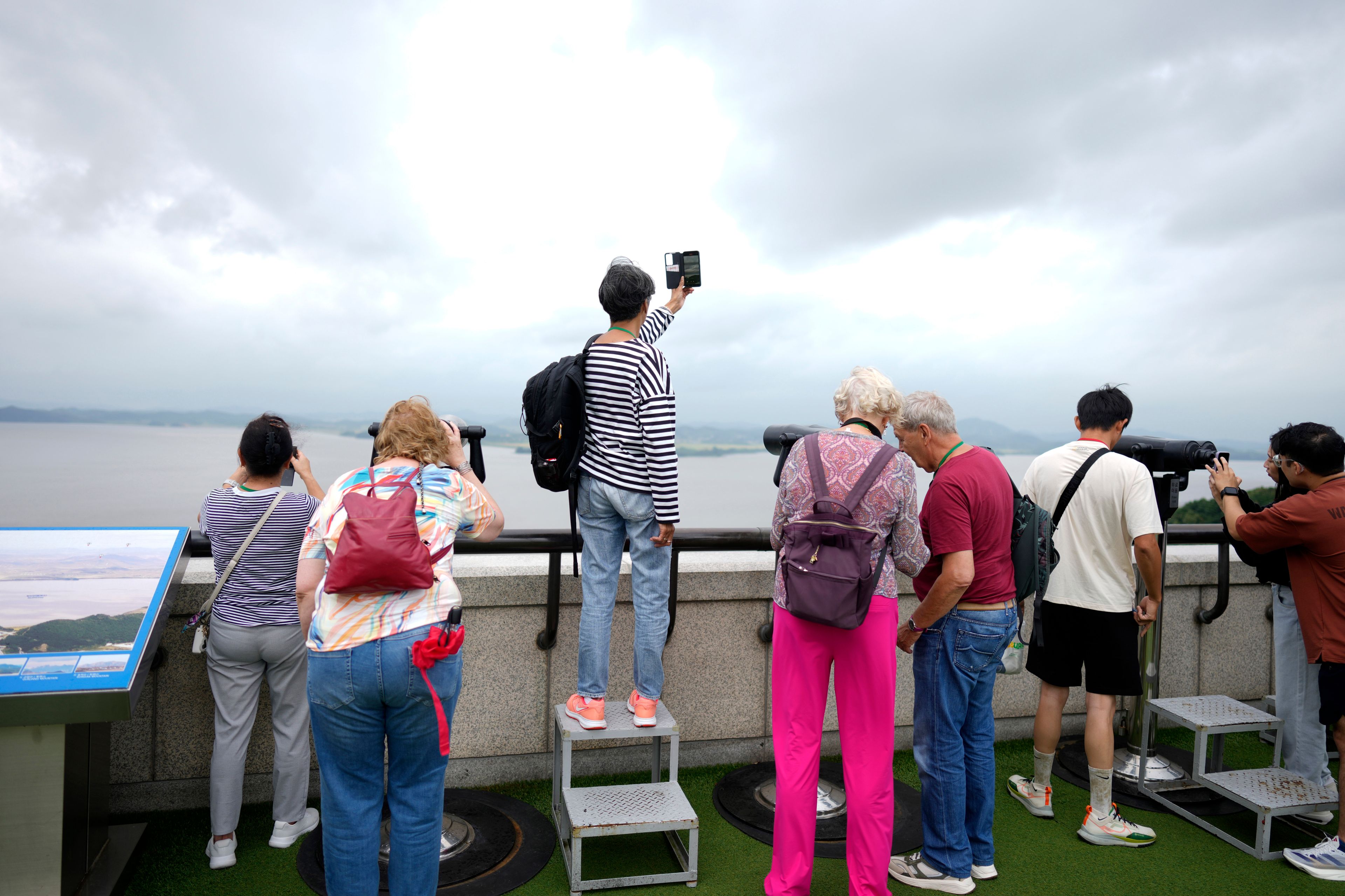 Visitors look at the North Korean side from the unification observatory in Paju, South Korea, Thursday, Sept. 5, 2024. (AP Photo/Lee Jin-man)