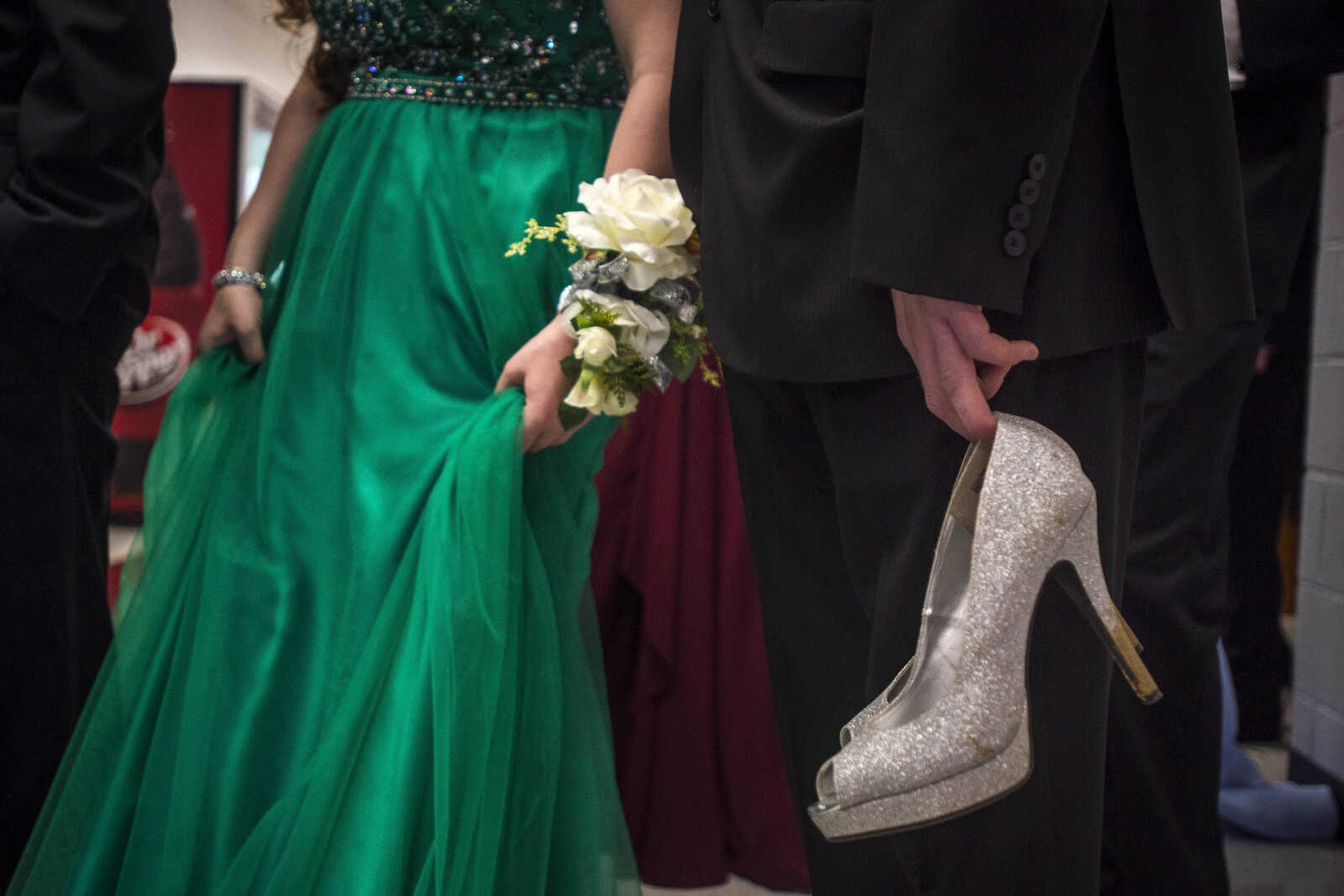 Rodney Samples, right, holds his date Angie Samples's high-heels as the two wait to process before friends and family before prom Saturday, April 6, 2019, at Kelly High School in Benton. 
"I'm holding 'em because she asked me to," he said.