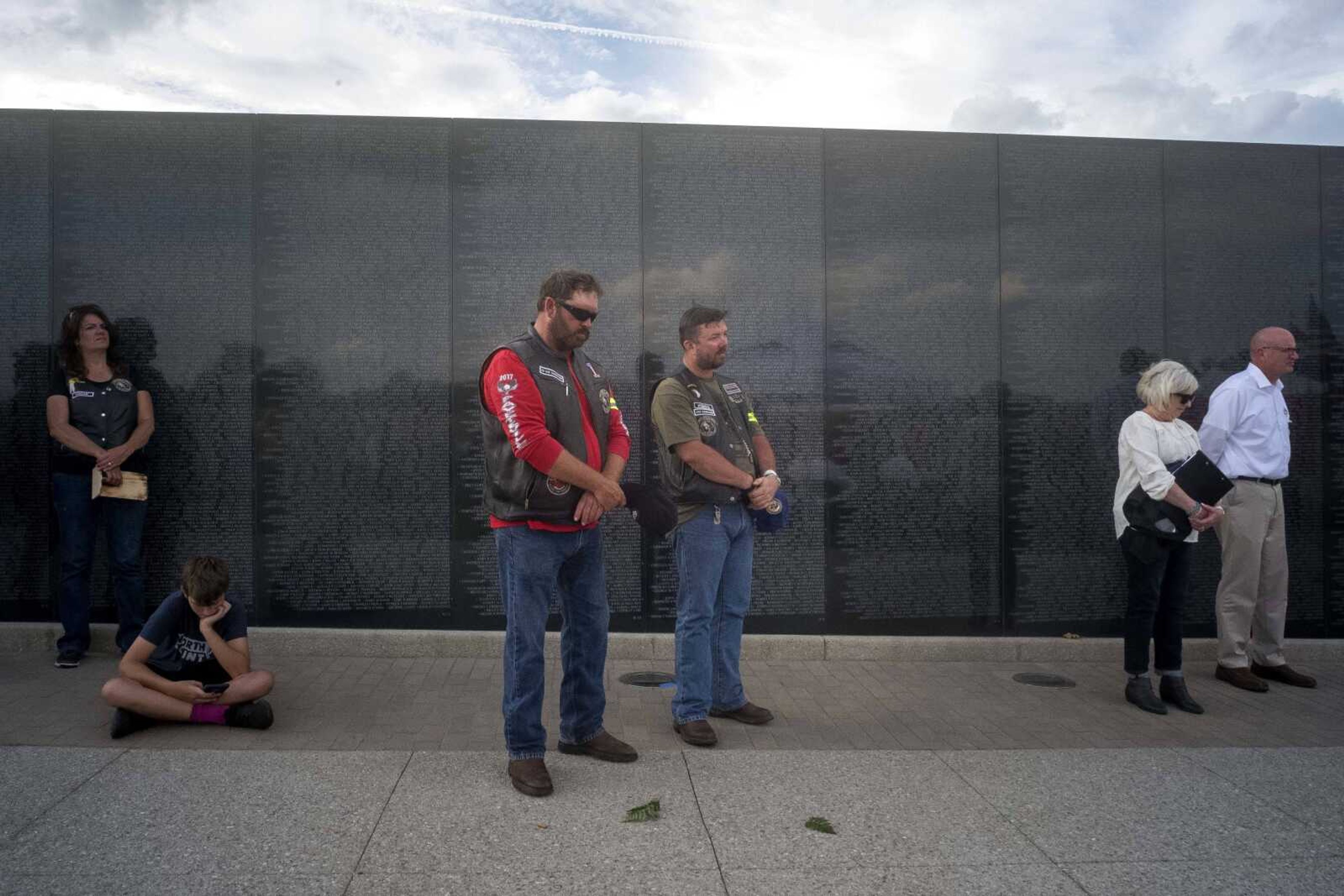 Ken Taylor, center left, and Daniel Lowery, center right, bow their heads for a moment of silence as the names of POW/MIA names from Missouri are read during the first-ever Missouri Vietnam Wall Run  Saturday, Sept. 21, 2019, at the Missouri's National Veterans Memorial in Perryville.