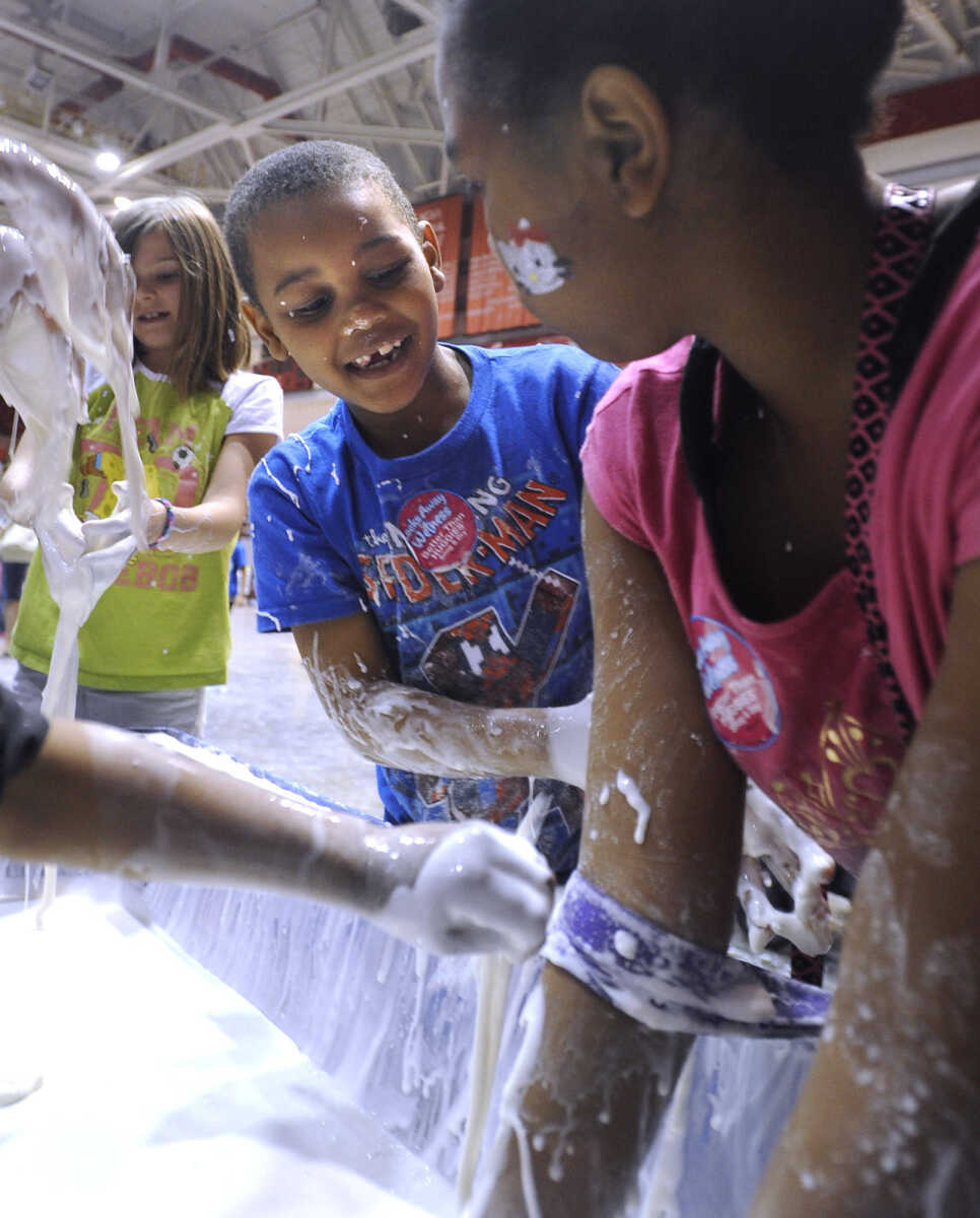 Austin Waddy and his sister, Ariana Waddy of Villa Ridge, Illinois play with pasty slime at the Messy Morning event Saturday, April 25, 2015 at the Show Me Ce