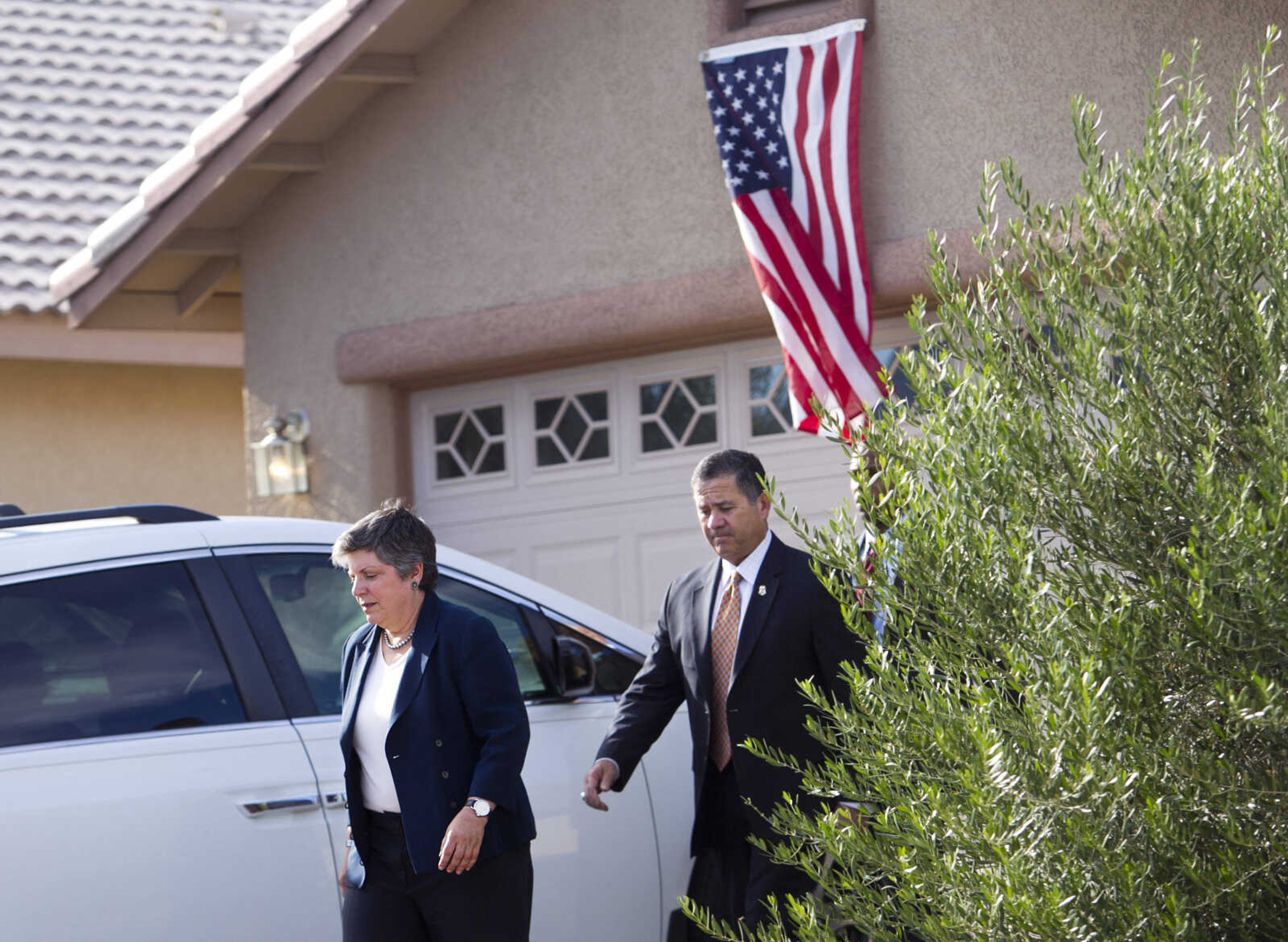 Secretary of Homeland Security Janet Napolitano, left, and Customs and Border Protection Deputy Commissioner David Aguilar exit the home of Border Patrol Agent Nicholas Ivie in Sierra Vista, Ariz. on Friday, Oct. 5, 2012. Ivie was shot and killed earlier in the week. A preliminary investigation has found friendly fire likely was to blame in the shootings of two border agents along the Arizona-Mexico border, the FBI said Friday. (AP Photo/The Arizona Republic, David Wallace)