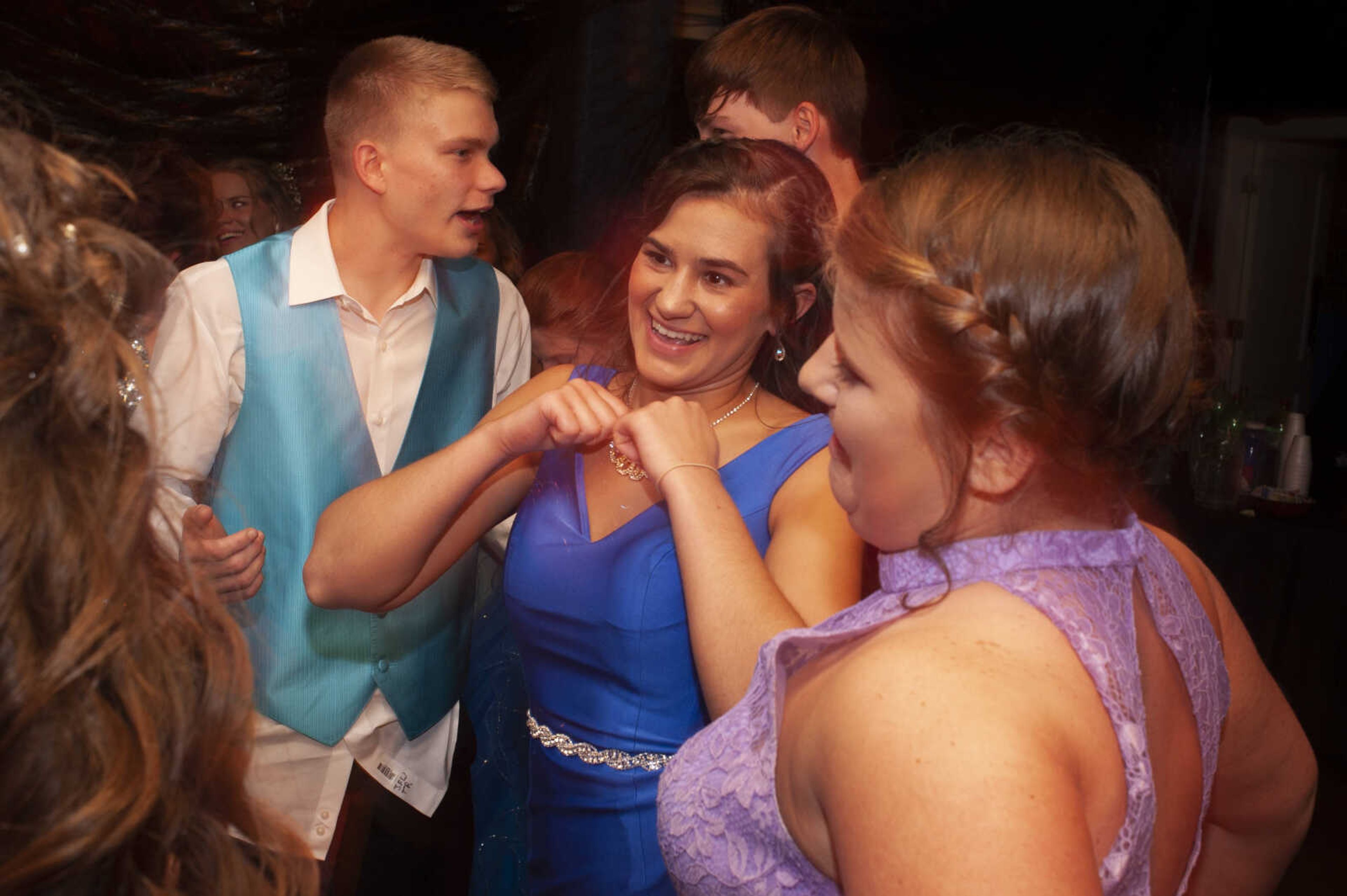 Leopold junior Kara Hampton, center, and Leopold sophomore Cameron Abernathy, left, dance during Leopold High School's "Masquerade at Midnight" prom Saturday, April 27, 2019, in Leopold.