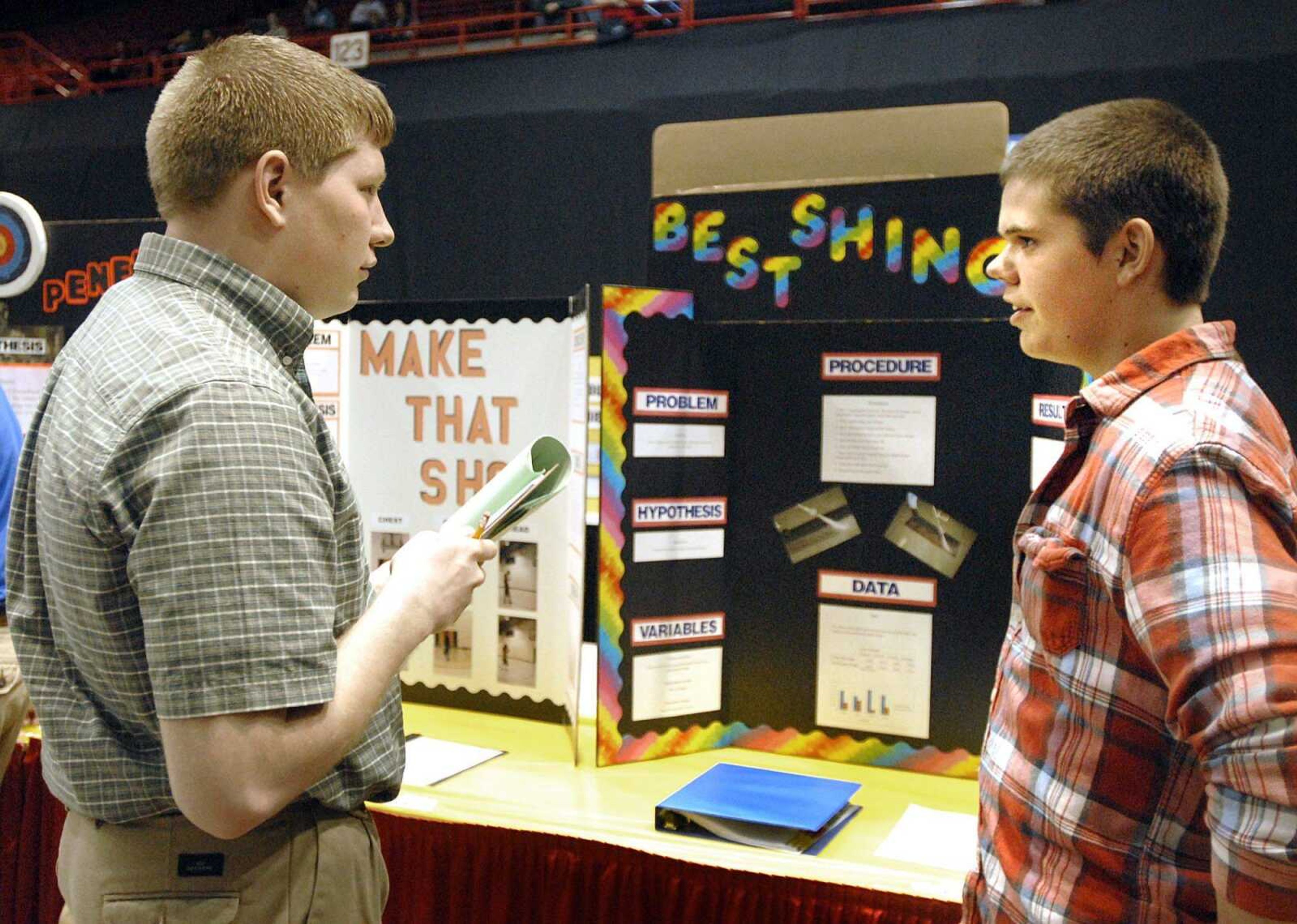 Judge Richard Seyer, lefft, questions eighth grade Kelso C-7 student Kendall Kern about his science fair project, "Best Shingle" Tuesday, March 6, 2012 at the Show Me Center in Cape Girardeau. (Laura Simon)