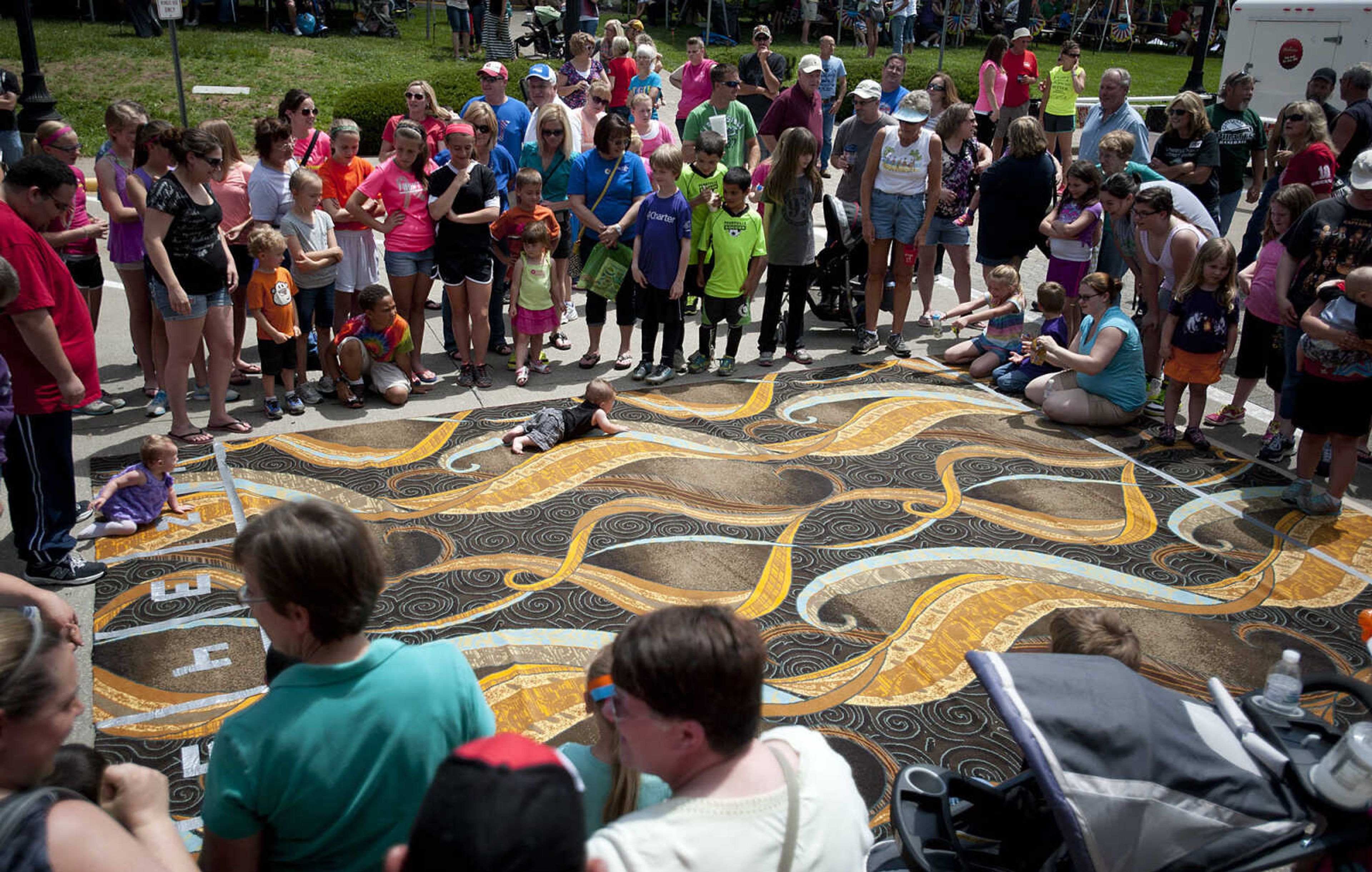 Levi Little crawls for third place in the Diaper Derby during Perryville Mayfest Saturday, May 10, in Perryville, Mo.