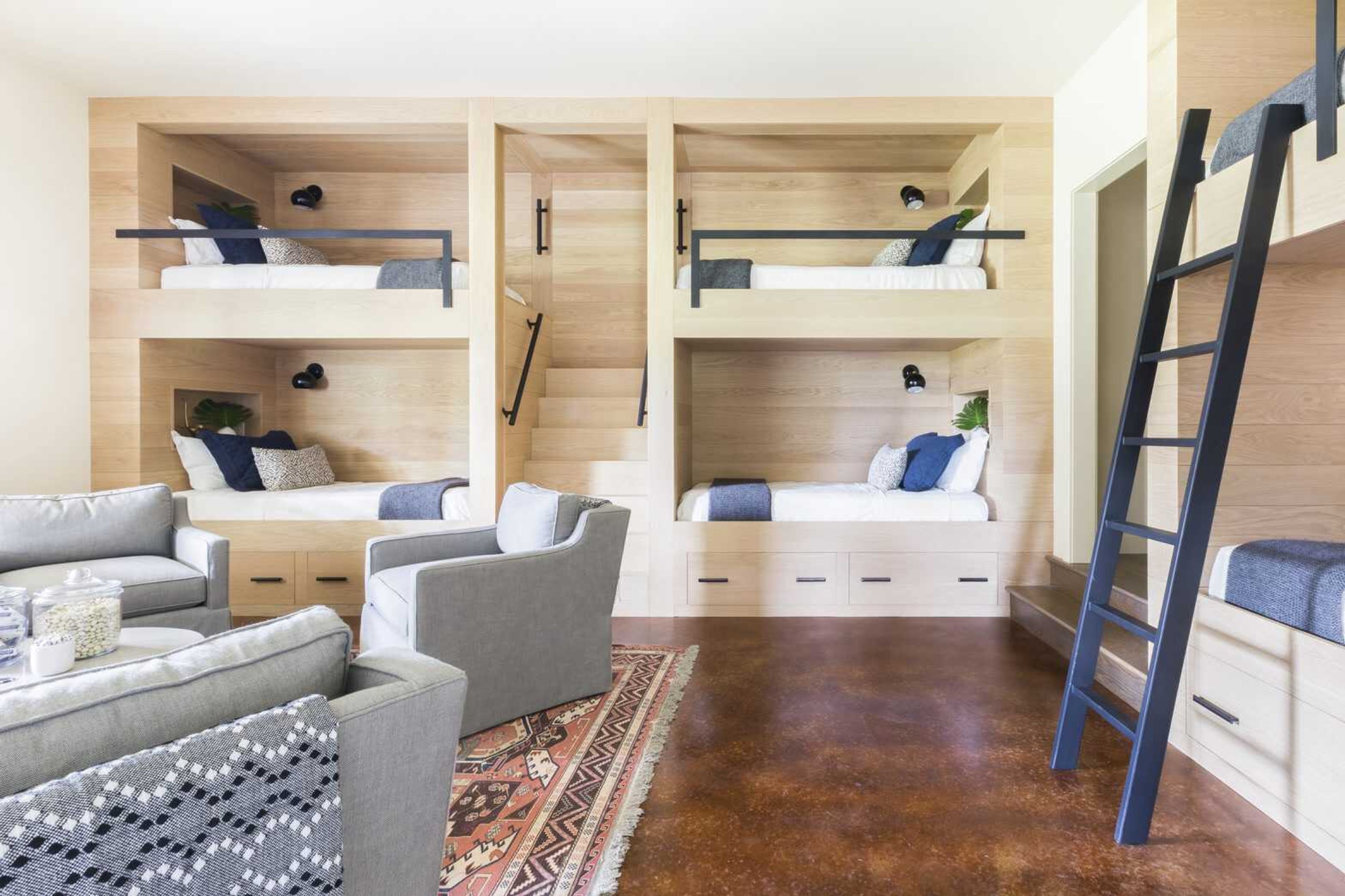 This photo provided by Tulsa-based designer Mel Bean shows a playroom she designed in Grand Lake, Oklahoma. Bean maximized this Grand Lake playroom by building in lots of sleepover space around the perimeter. Bean has a tip for families planning playroom spaces.