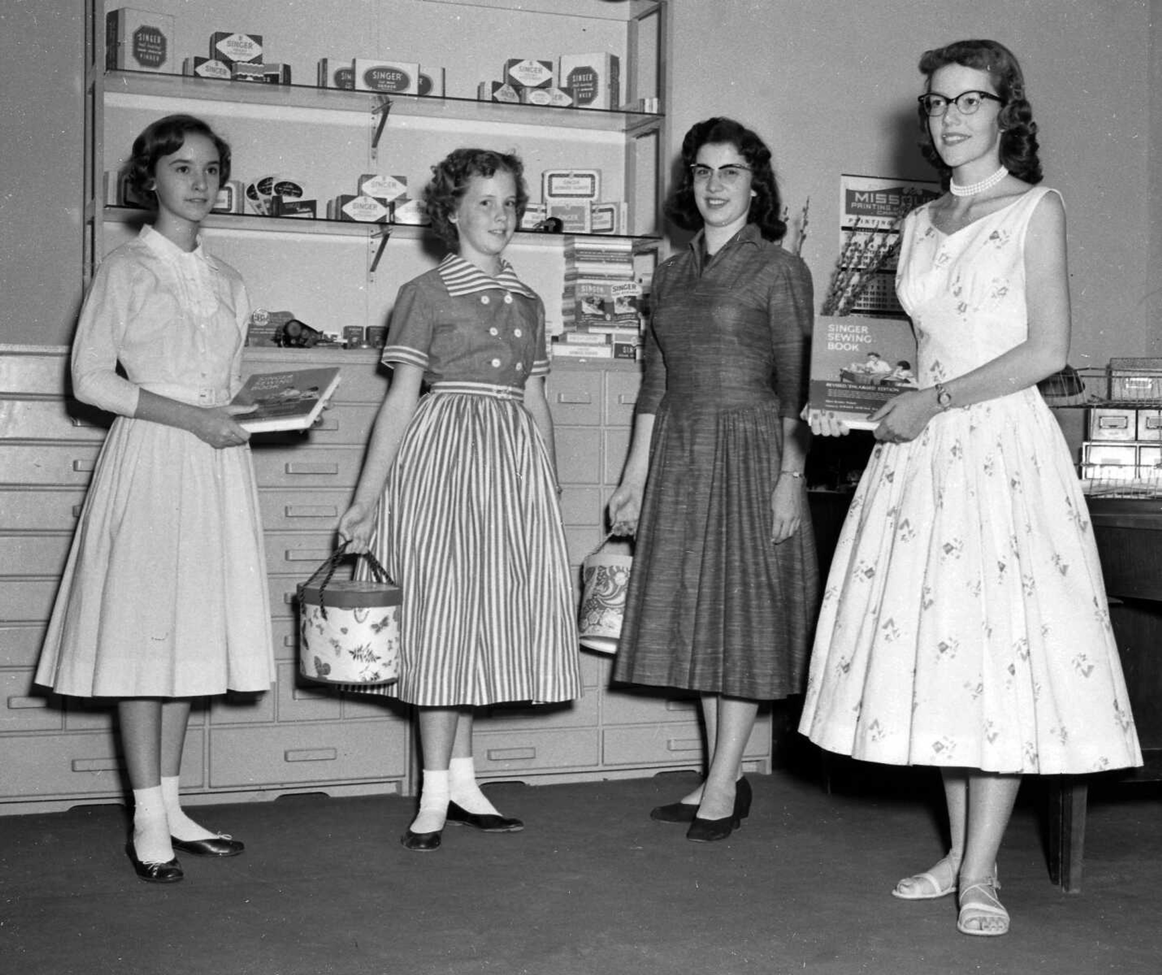 These four young women are unidentified, but they were probably modeling home-made dresses for a Singer sewing store. Anne Lamkin Kinder identified herself in the photo. “It was about 1956 or ’57. I’m second from left.” Mallory Lynn writes: "Lady on the far left is my grandma, Carolyn (Patrick) Young."