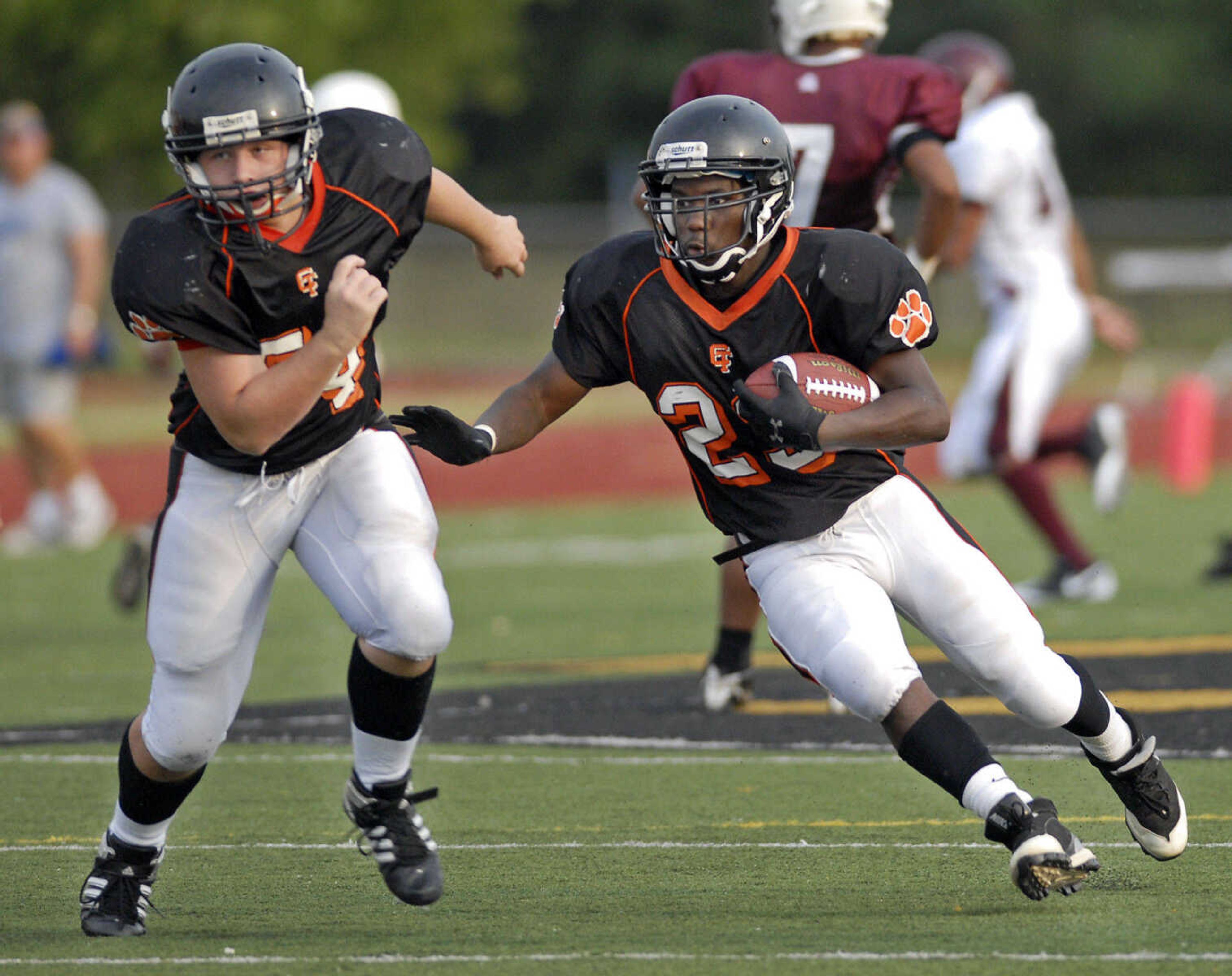 KRISTIN EBERTS ~ keberts@semissourian.com

Cape Central's Deonte Jenkins runs the ball as teammate David Huffman, left, blocks during a jamboree game against St. Clair on Friday, August 20, 2010, at Farmington High School.