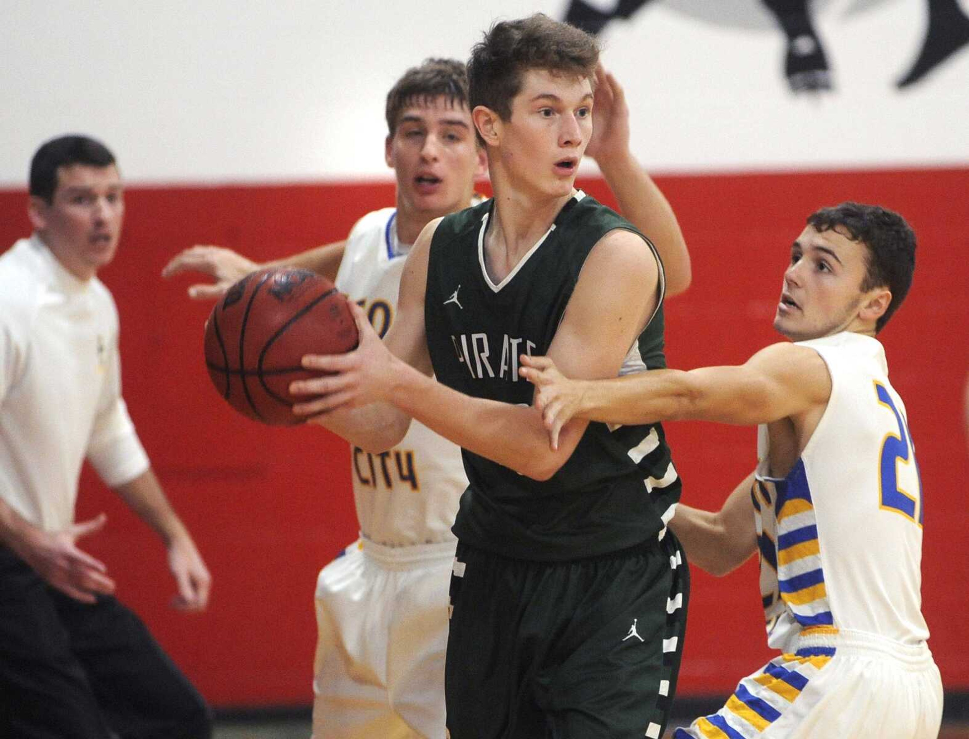 Perryville's Conner Stark looks to pass between Scott City's Trent Pobst, left, and Nick Bickings during the second quarter of the championship game in the Woodland Invitational on Friday, Dec. 4, 2015 in Marble Hill, Missouri. (Fred Lynch)