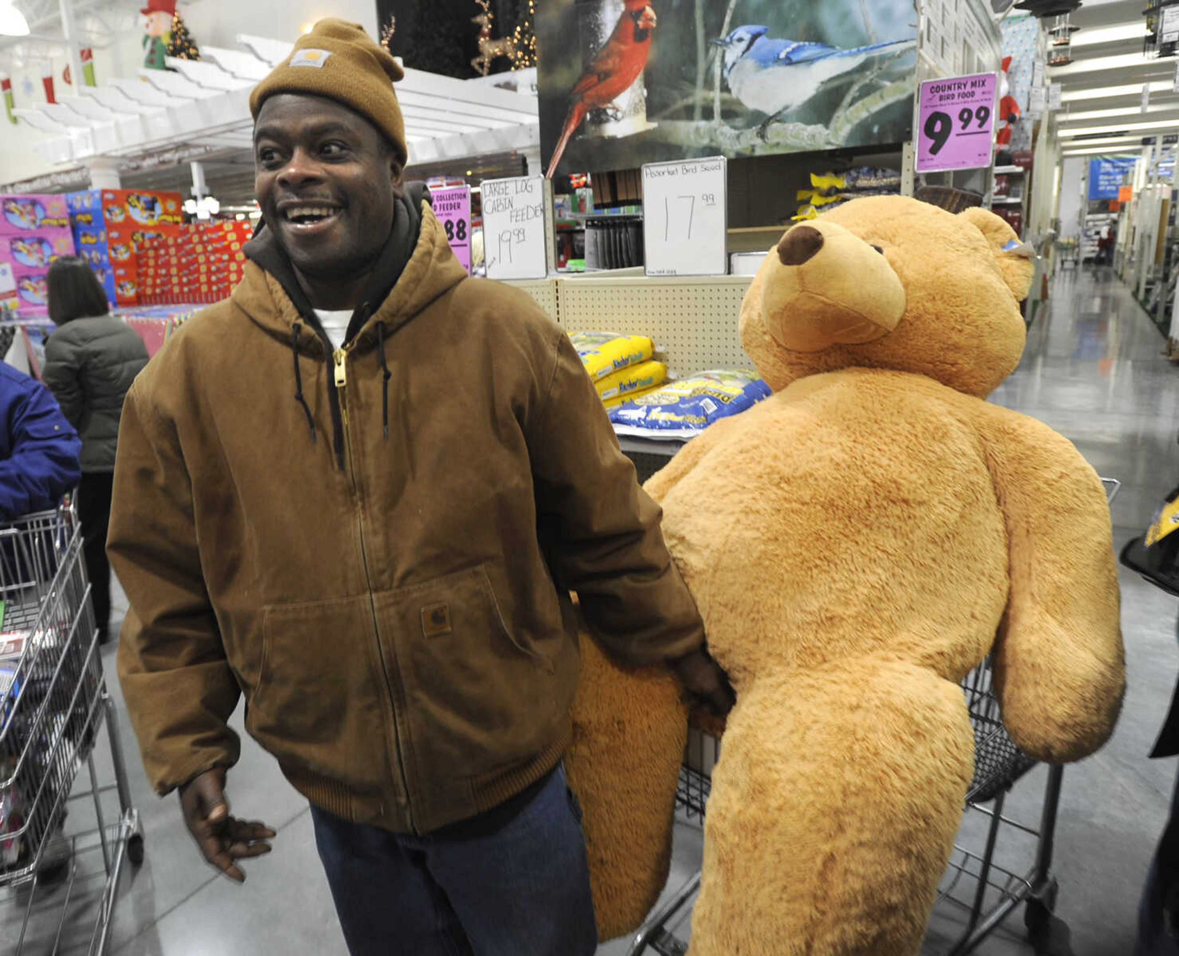 Anthony Peairs of Cape Girardeau maneuvers through Menards with his purchase on Black Friday, Nov. 29, 2013.