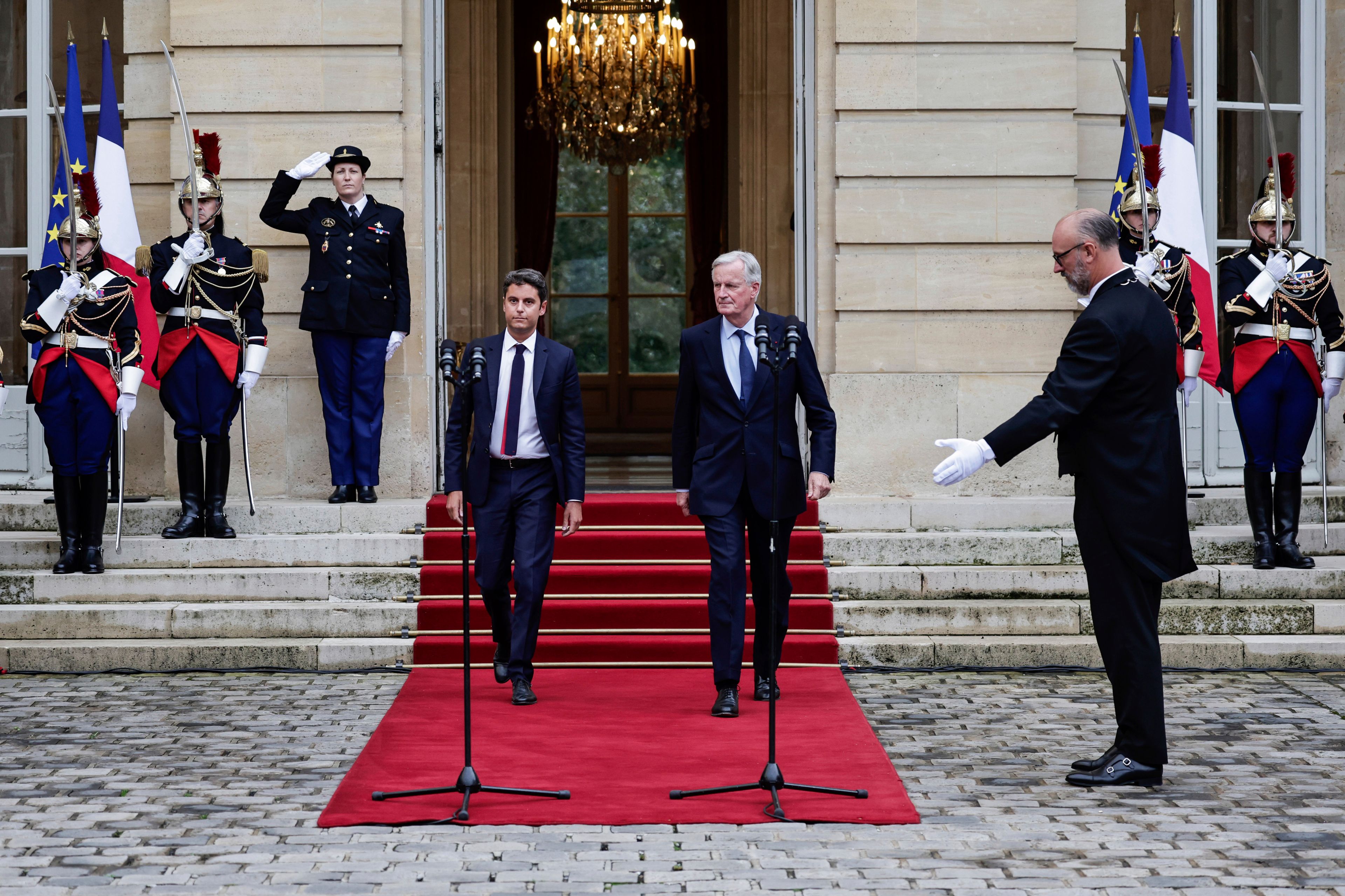 New French prime minister Michel Barnier, center right, and outgoing prime minister Gabriel Attal, center left, arrive to deliver a speech during the handover ceremony, Thursday, Sept. 5, 2024 in Paris. President Emmanuel Macron has named EU's Brexit negotiator Michel Barnier as France's new prime minister after more than 50 days of caretaker government. (Stephane de Sakutin/Pool Photo via AP)