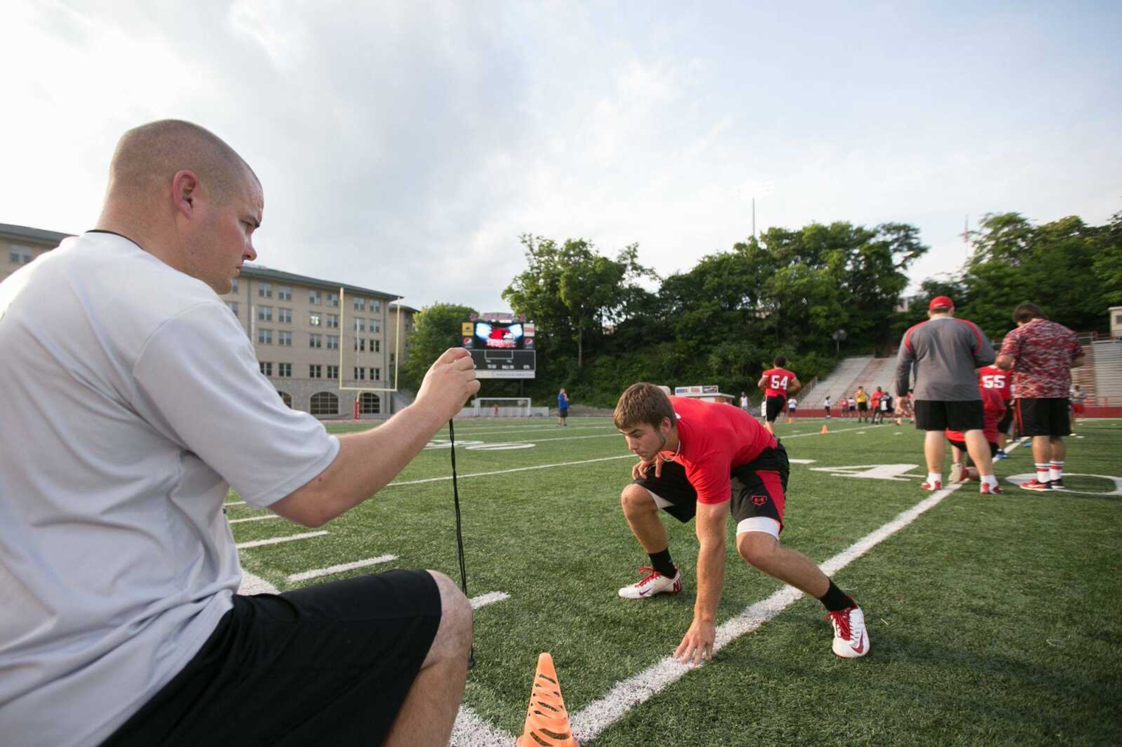 GLENN LANDBERG ~ glandberg@semissourian.com    Marshall Grammer preforms a running drill for Southeast Missouri State University's running back coach  Matt Martin during a football prospect camp at Houck Stadium, Friday, June 5, 2015.