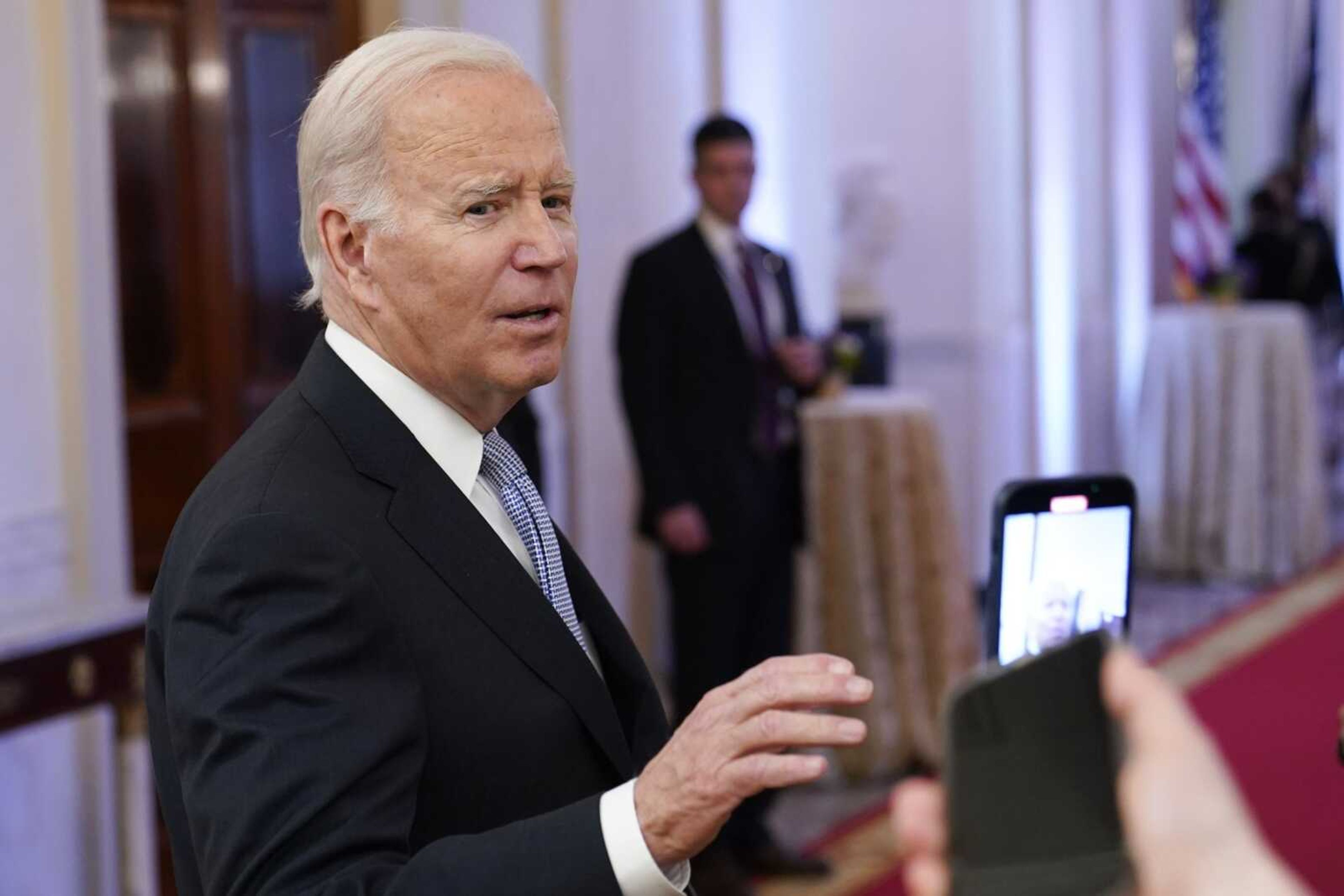 President Joe Biden talks with reporters after speaking in the East Room of the White House on Jan. 20 in Washington. A new poll shows that more U.S. adults disapprove than approve of the way President Joe Biden has handled the discovery of classified documents at his home and former office. Yet that seems to have had little impact on Biden's overall approval rating.