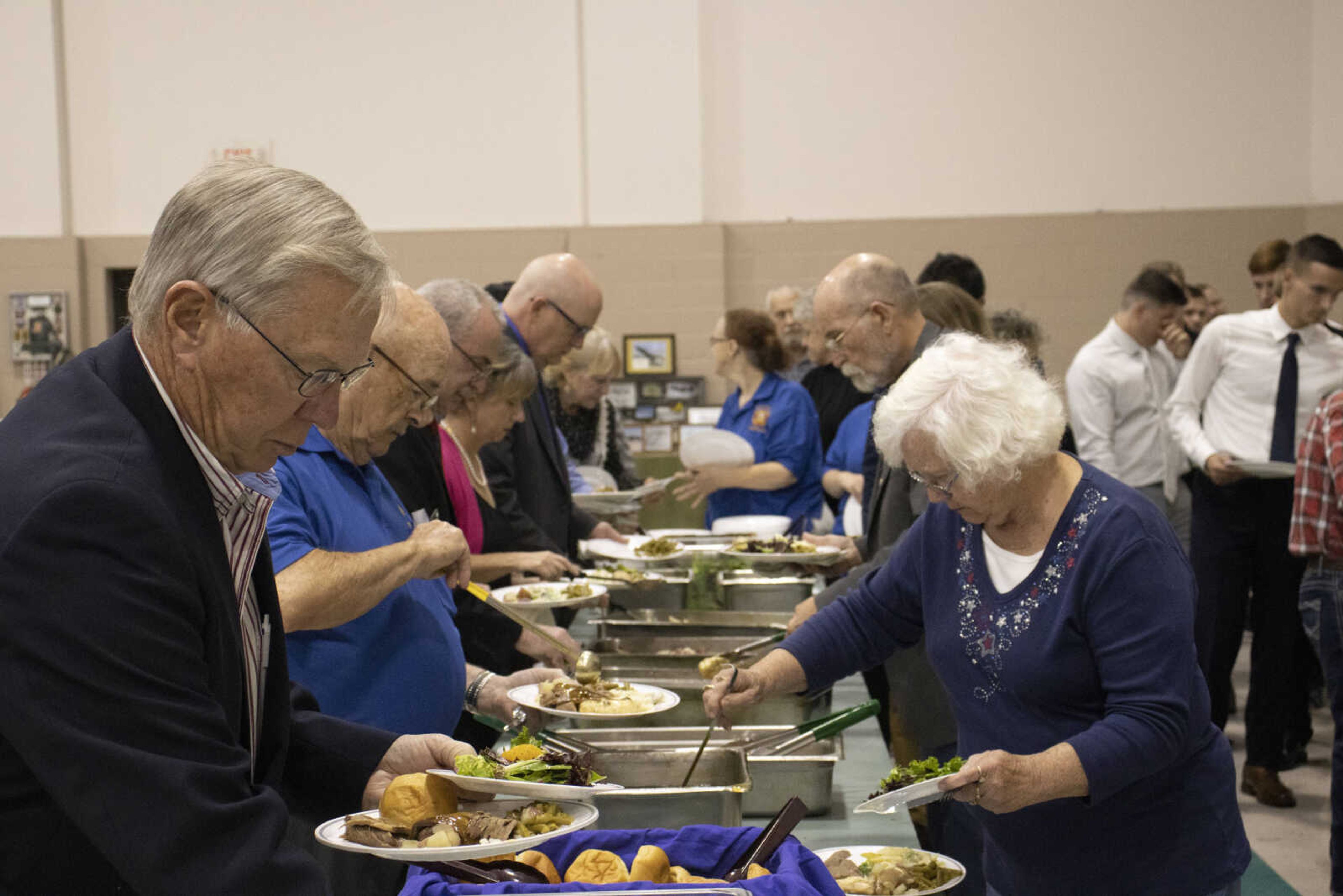 Guests line up for food at the Spirit of Democracy dinner on Saturday.