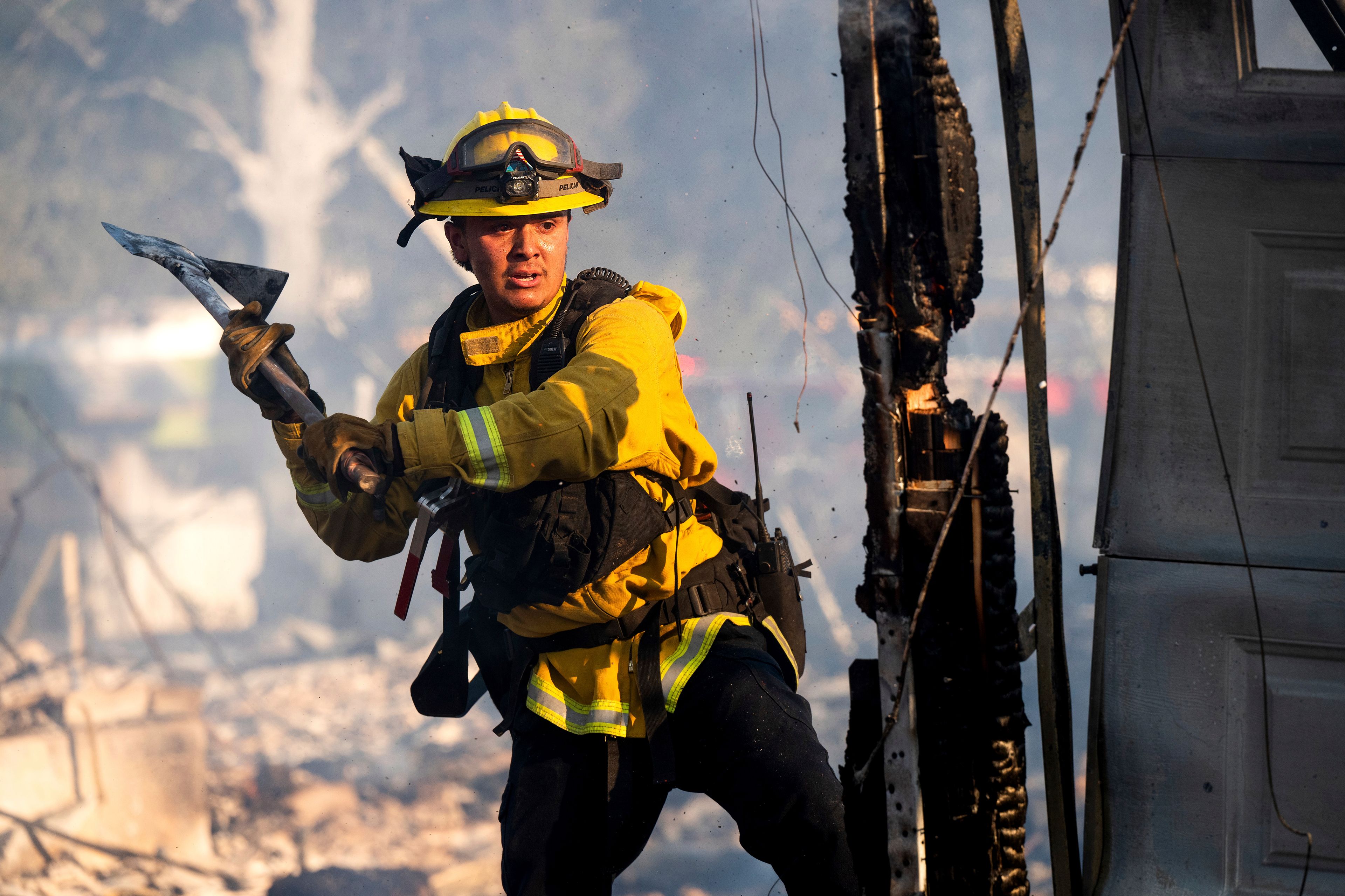 Firefighter Jonathan Lievanos extinguishes hot spots at a home destroyed by the Boyles fire in Clearlake, Calif., on Sunday, Sept. 8, 2024. (AP Photo/Noah Berger)