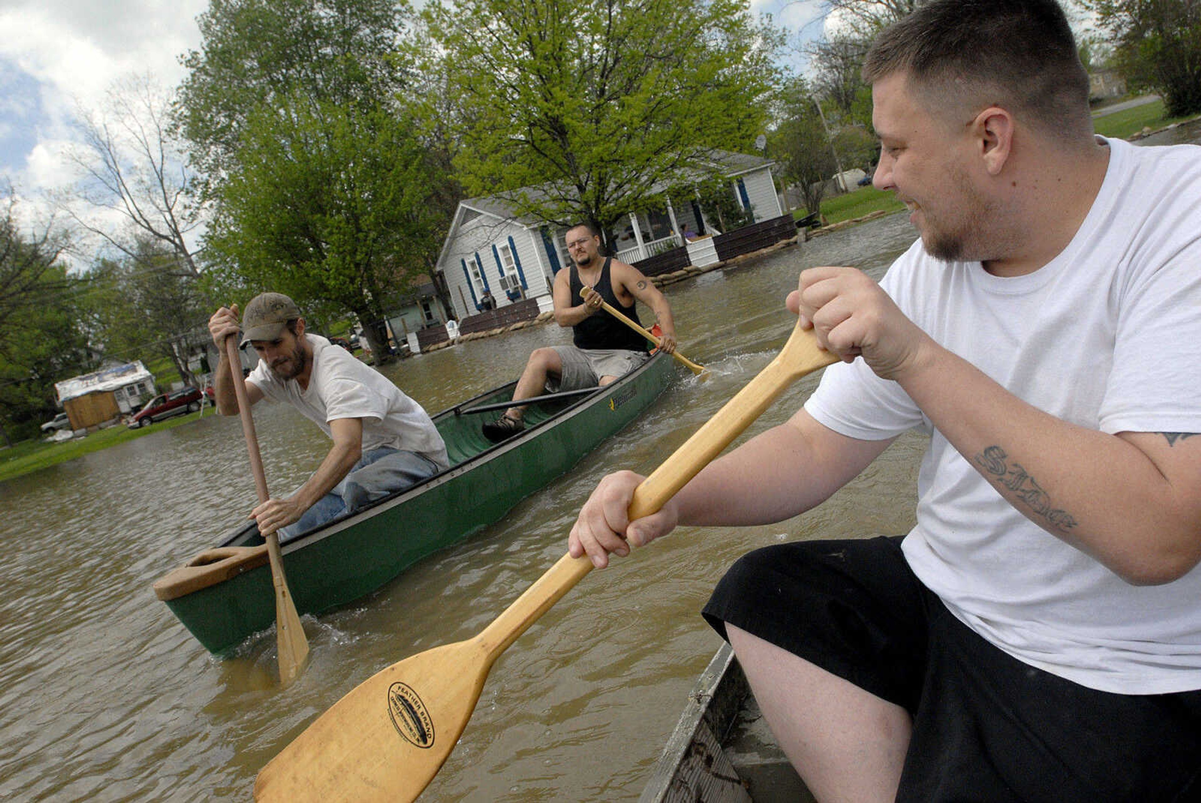 LAURA SIMON~lsimon@semissourian.com
Aaron Laughlin paddles out into the Mississippi River floodwater covering the Red Star district alongside Joshua Robertson, left, and Gabriel Yanes Thursday, April 28, 2011 in Cape Girardeau.