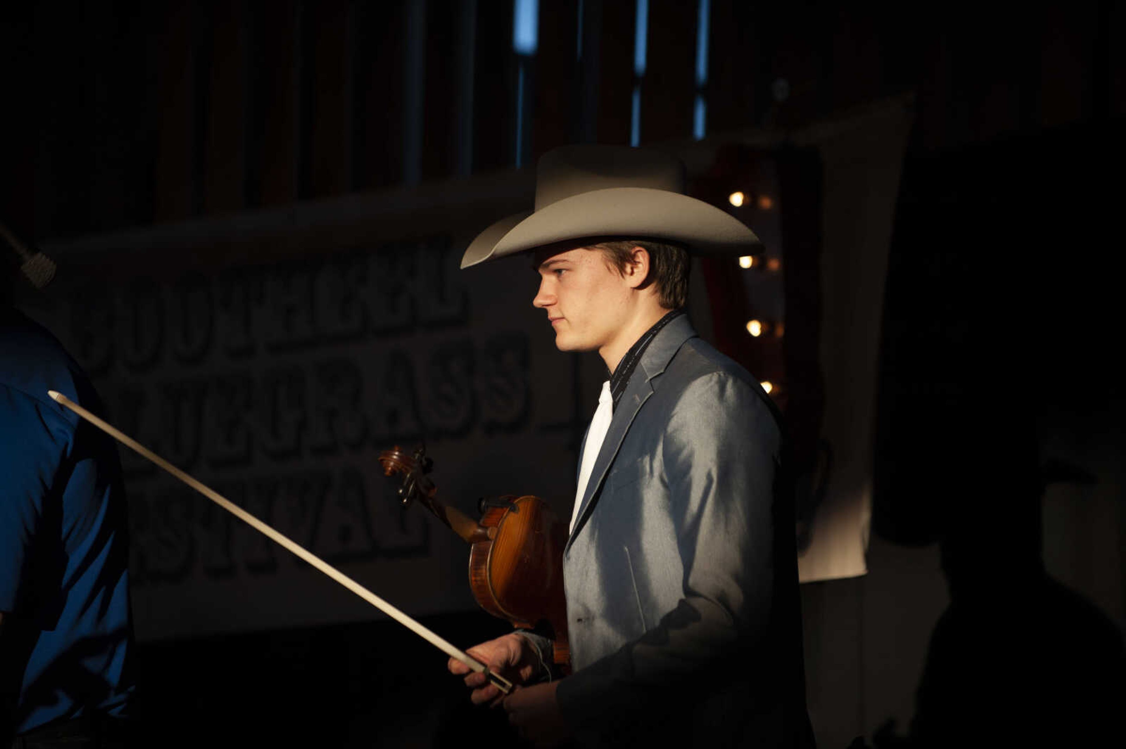 Trustin Baker of Birch Tree, Missouri, 19, takes the stage with his mother and siblings at the Bootheel Bluegrass Festival on Friday, Jan. 25, 2019, at the Bavarian Halle in Fruitland. The festival continues Saturday with more bluegrass.