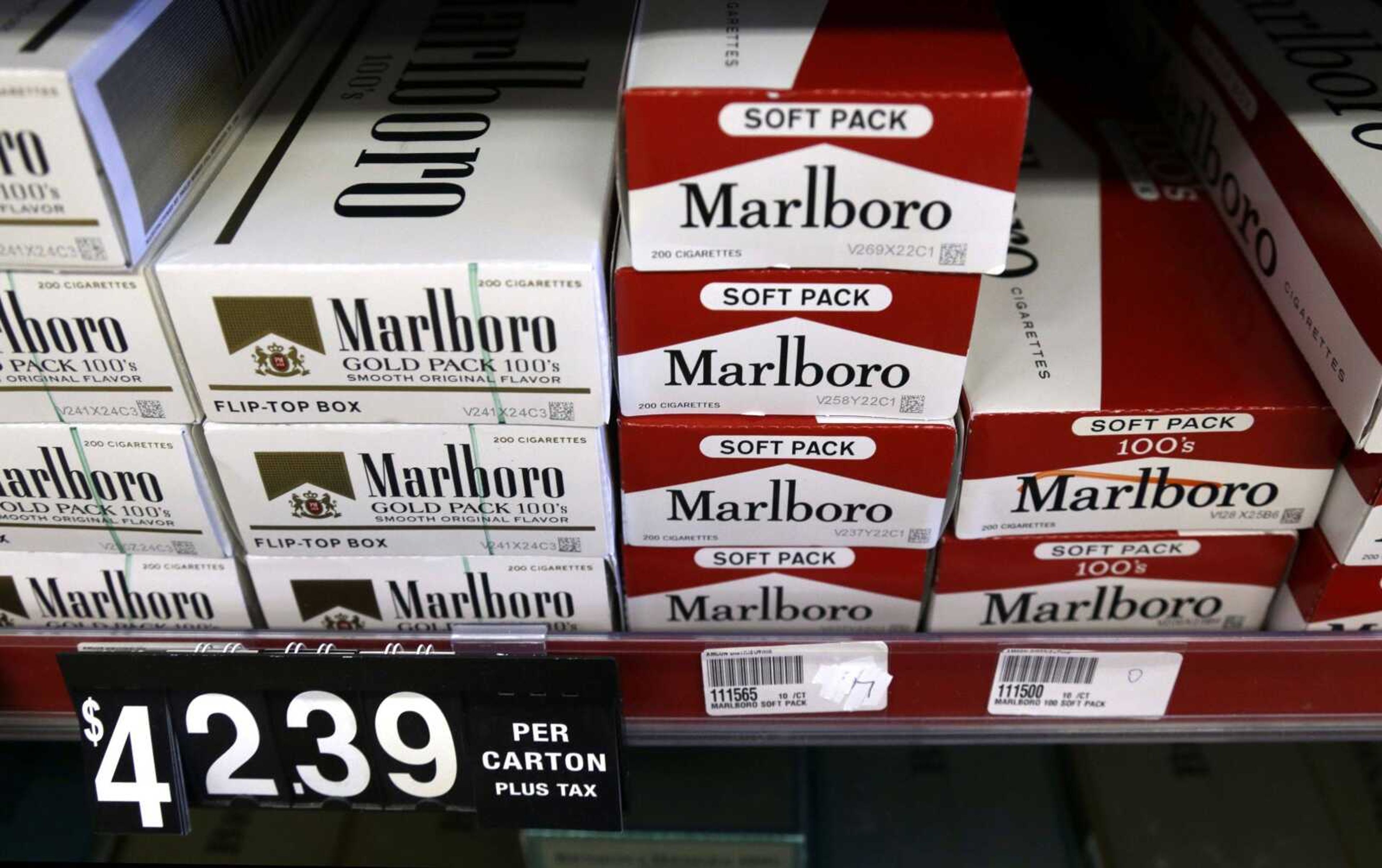 Cartons of cigarettes sit on shelves at Discount Smoke Shop in Ballwin, Missouri. Missouri's low tobacco tax will rise if at least one of two ballot measures passes in November.