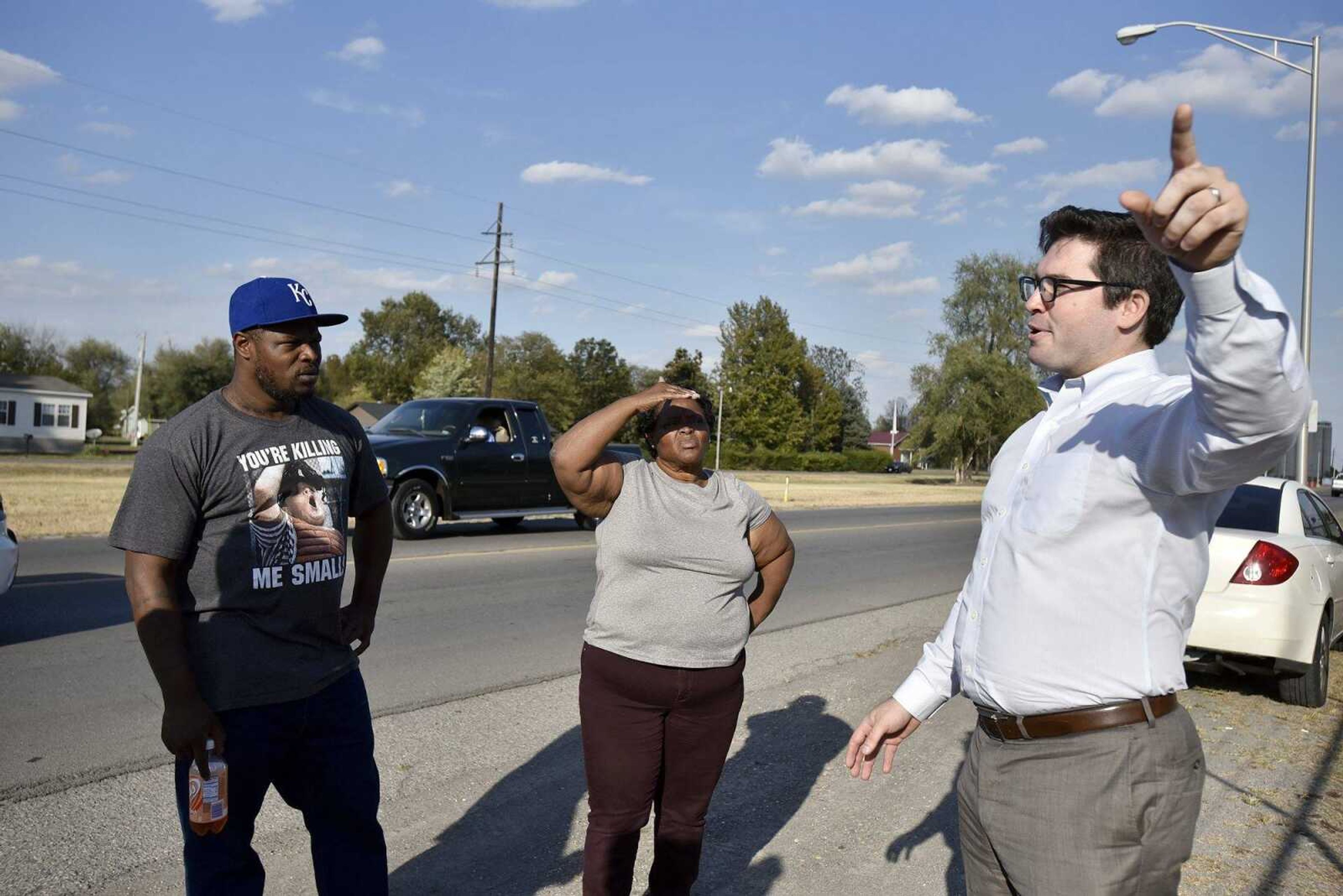 Jonathan Potts, one of David Robinson's attorneys, speaks with Robinson's mother, Jennett McCaster and brother Justin Robinson, along W. Malone Ave in Sikeston, Missouri.